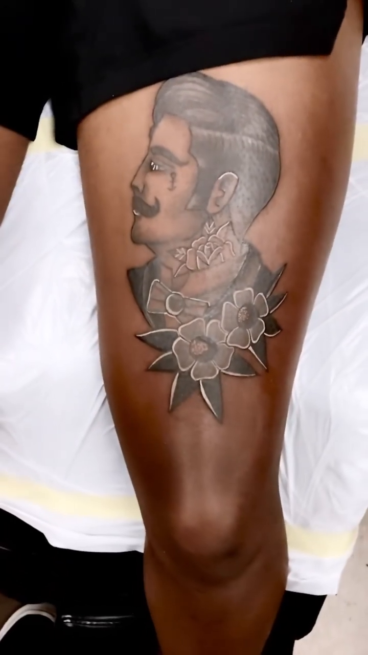Portrait of a man with flowers realism tattoo by Anahi
