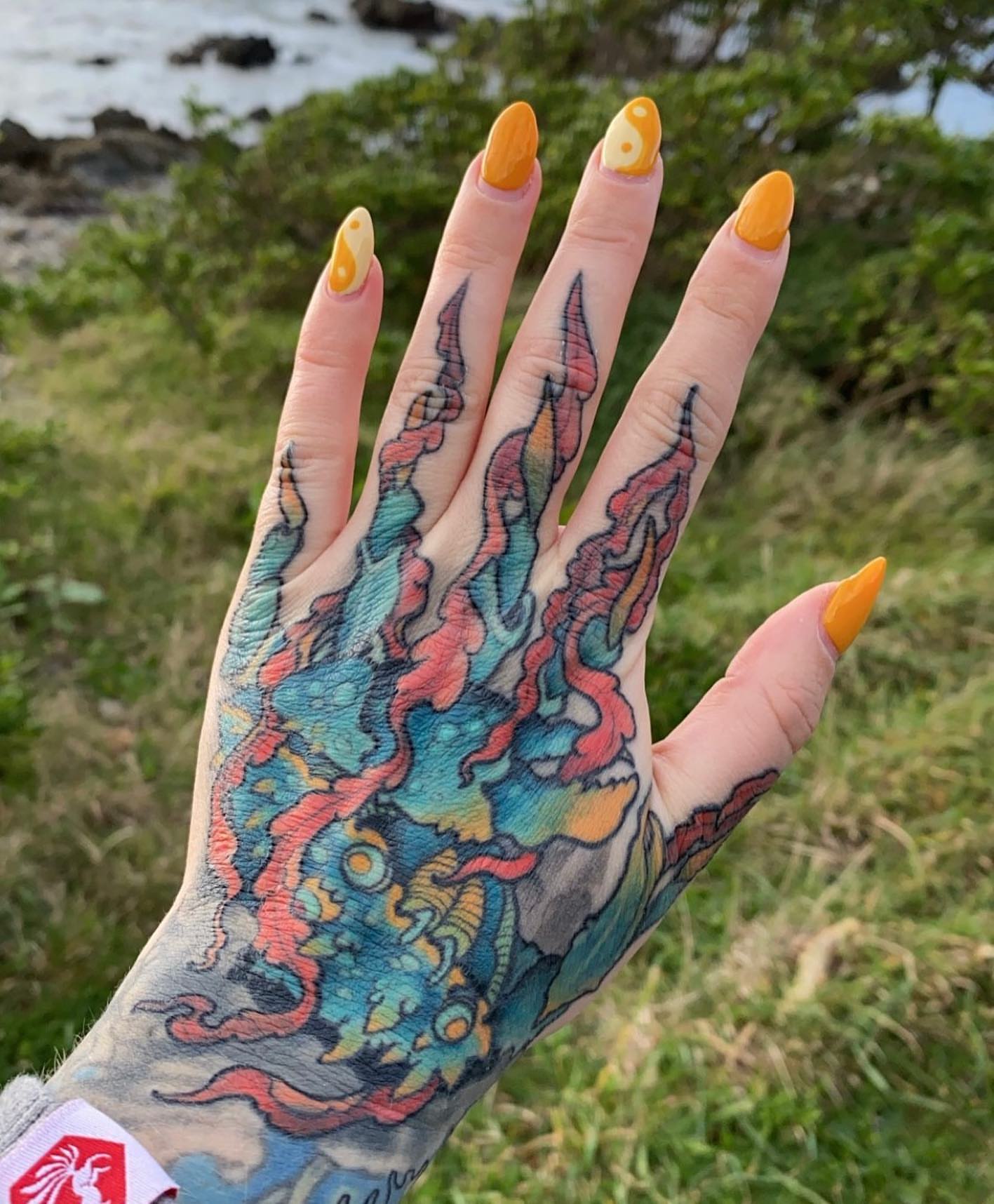 Octopus new school tattoo on the hand by Erin Chance