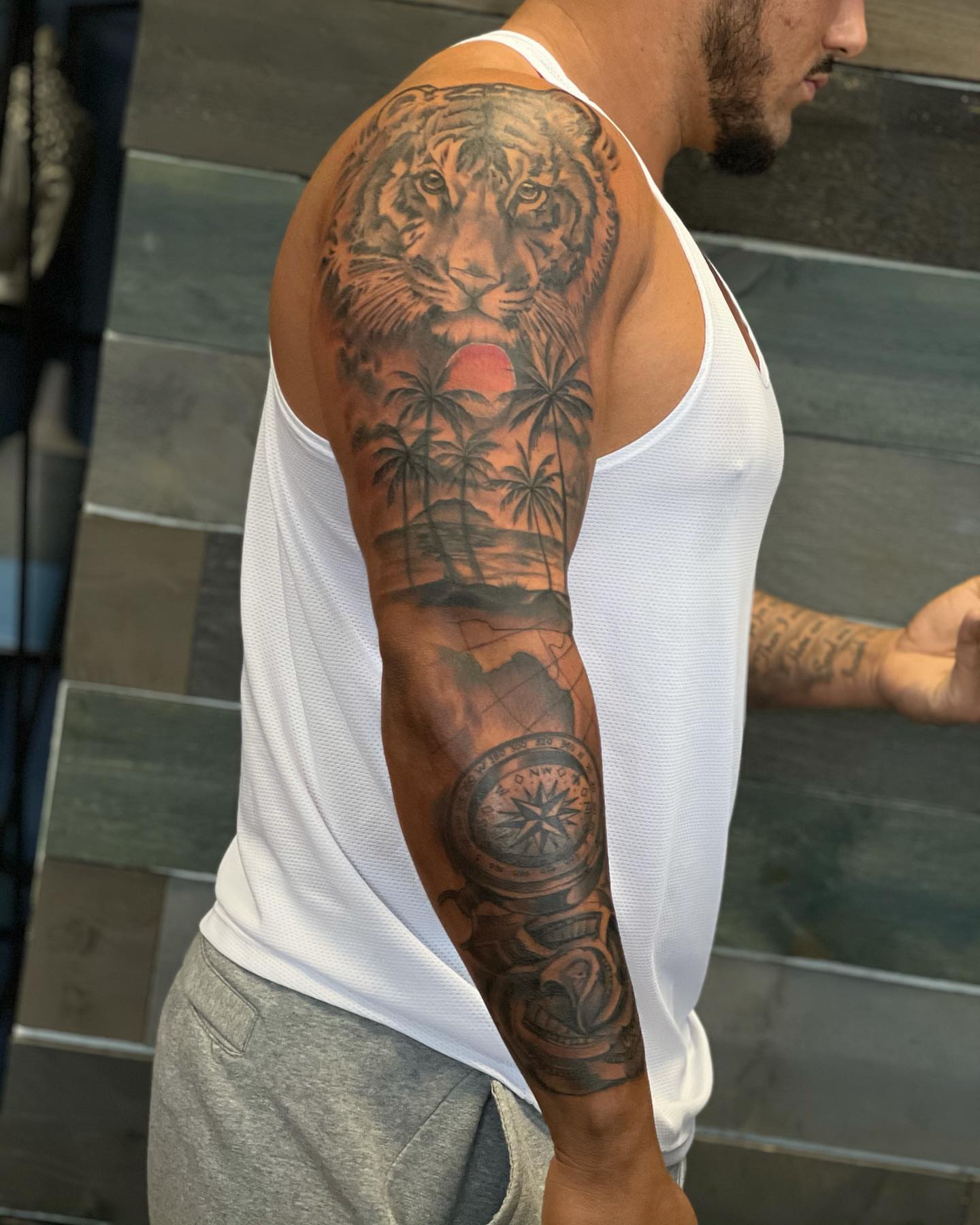 Tiger sunset realism tattoo on the upper arm by Mikeyftsk2