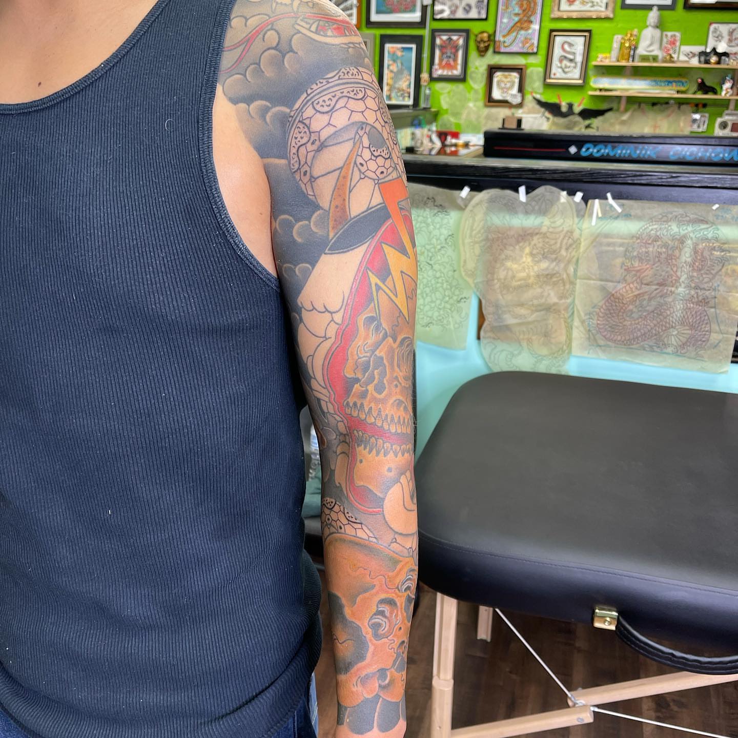 Skull American traditional tattoo on the upper arm by Mark Thompson, Dallas, Texas