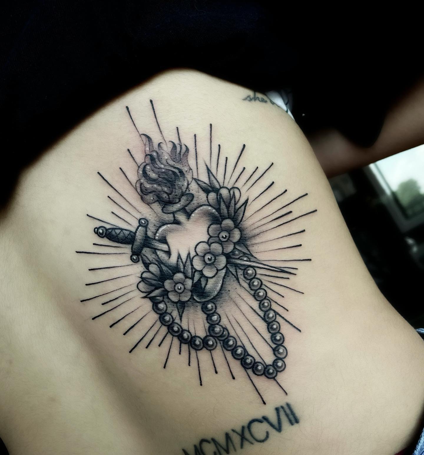 Heart with dagger black and grey tattoo on the shoulder by 𝖎 𝖆𝖒 𝖗𝖔𝖙𝖙𝖎𝖓𝖌 𝖜𝖎𝖙𝖍 𝖞𝖔𝖚