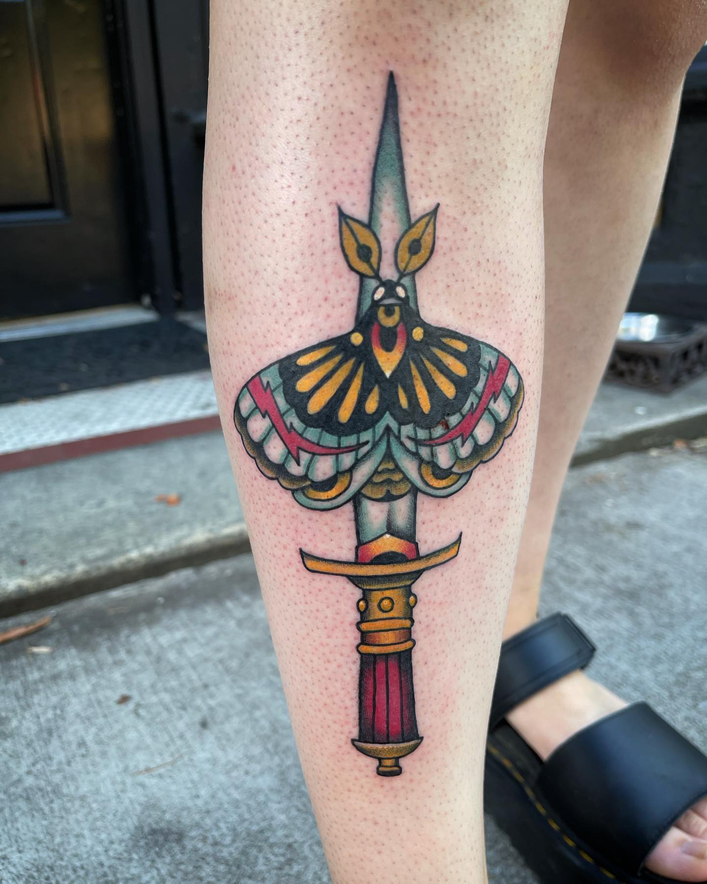 Moth and dagger American traditional tattoo on the forearm by Dave Shurman