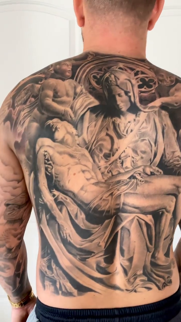 Pietà scene realism tattoo by Carlos Macedo Tattoo