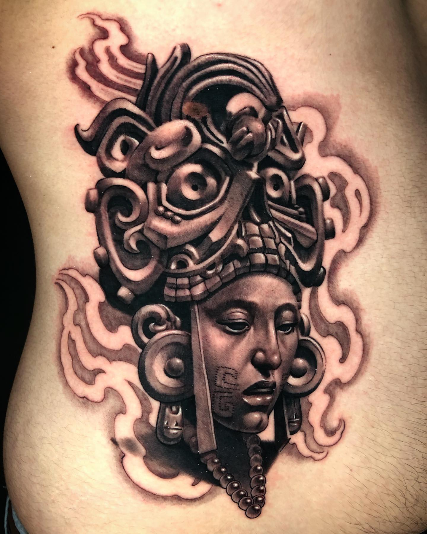 Ancient figure geometric tattoo on the ribs by David Torres