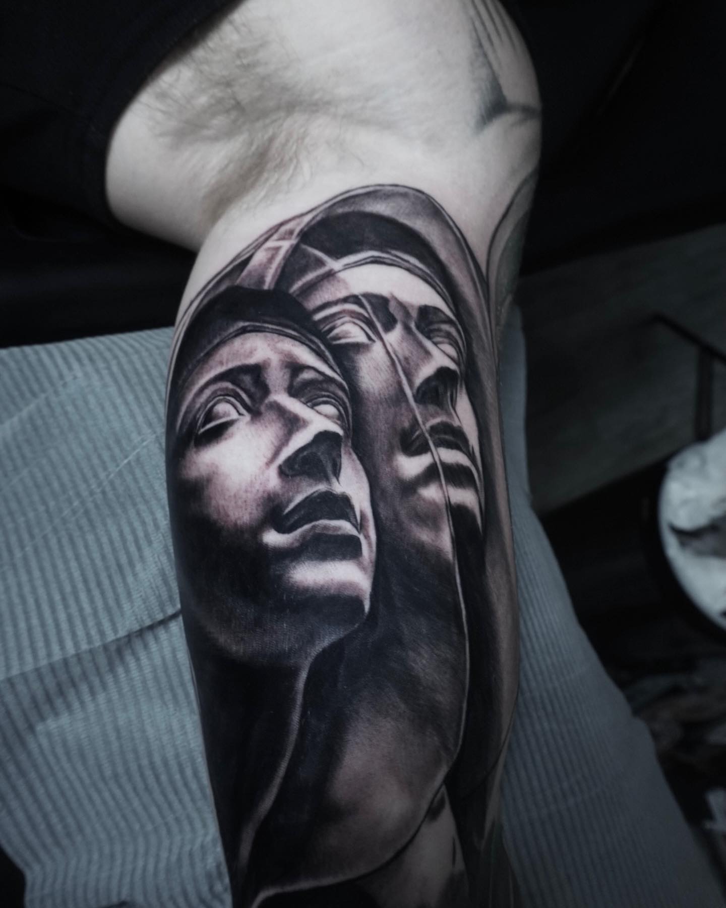 Two faces realism tattoo on the forearm by Brian Cassidy