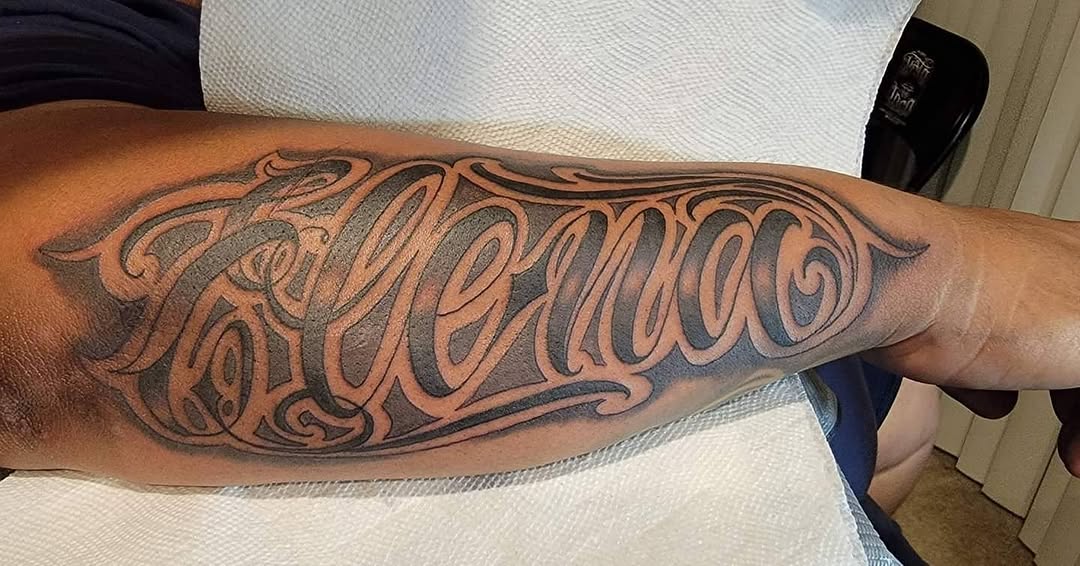 Tattoo by @tattoos.by.miguelc — lettering_script, chicano