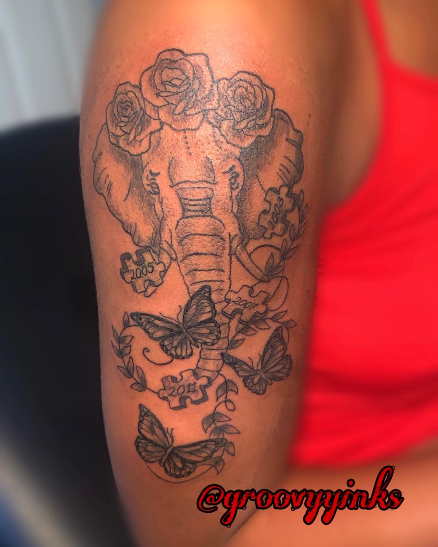 Elephant with roses black and grey tattoo on the forearm by groovyyinkss