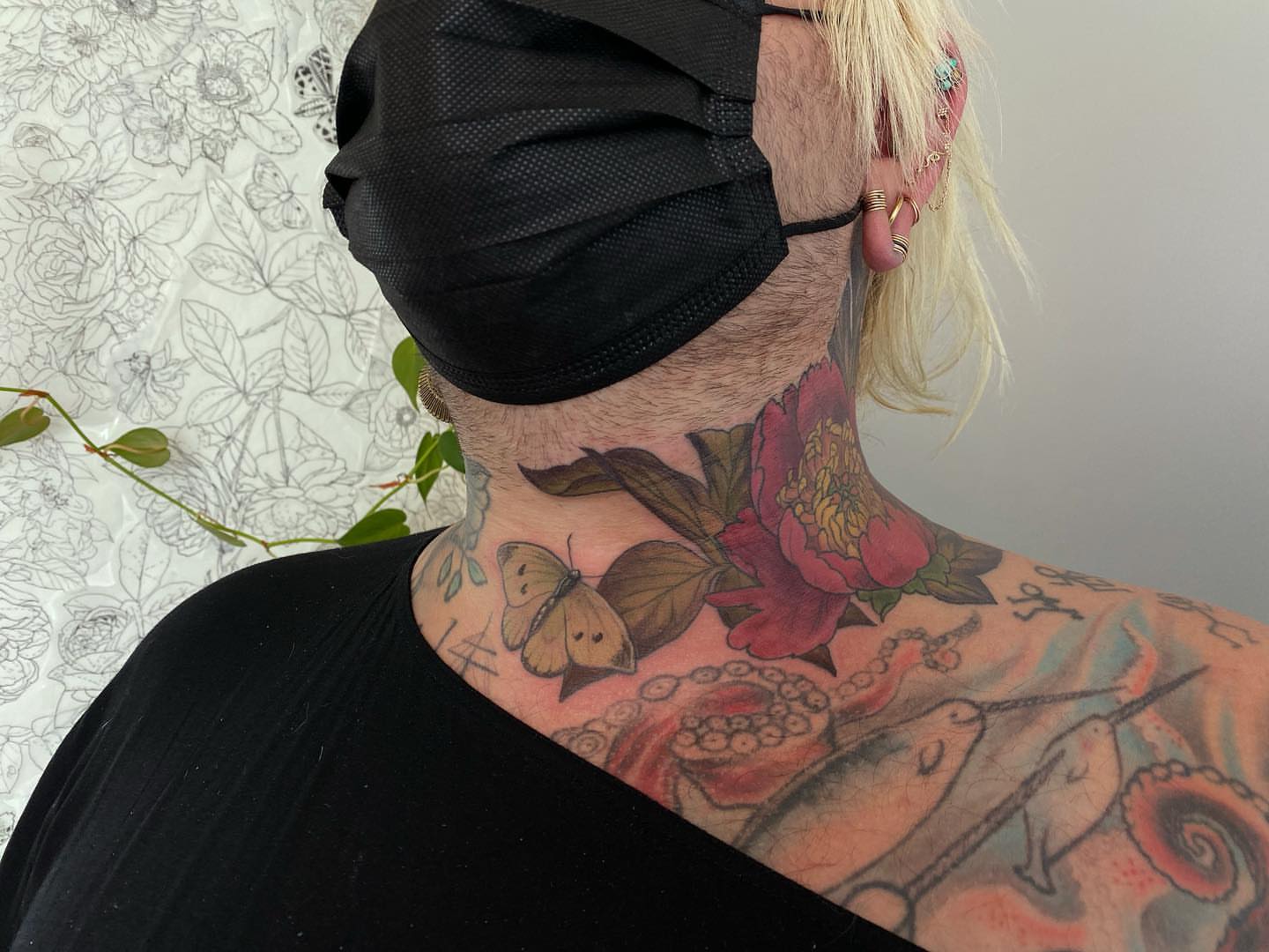 Butterfly and flower American traditional tattoo on the neck by Rusty Indigo