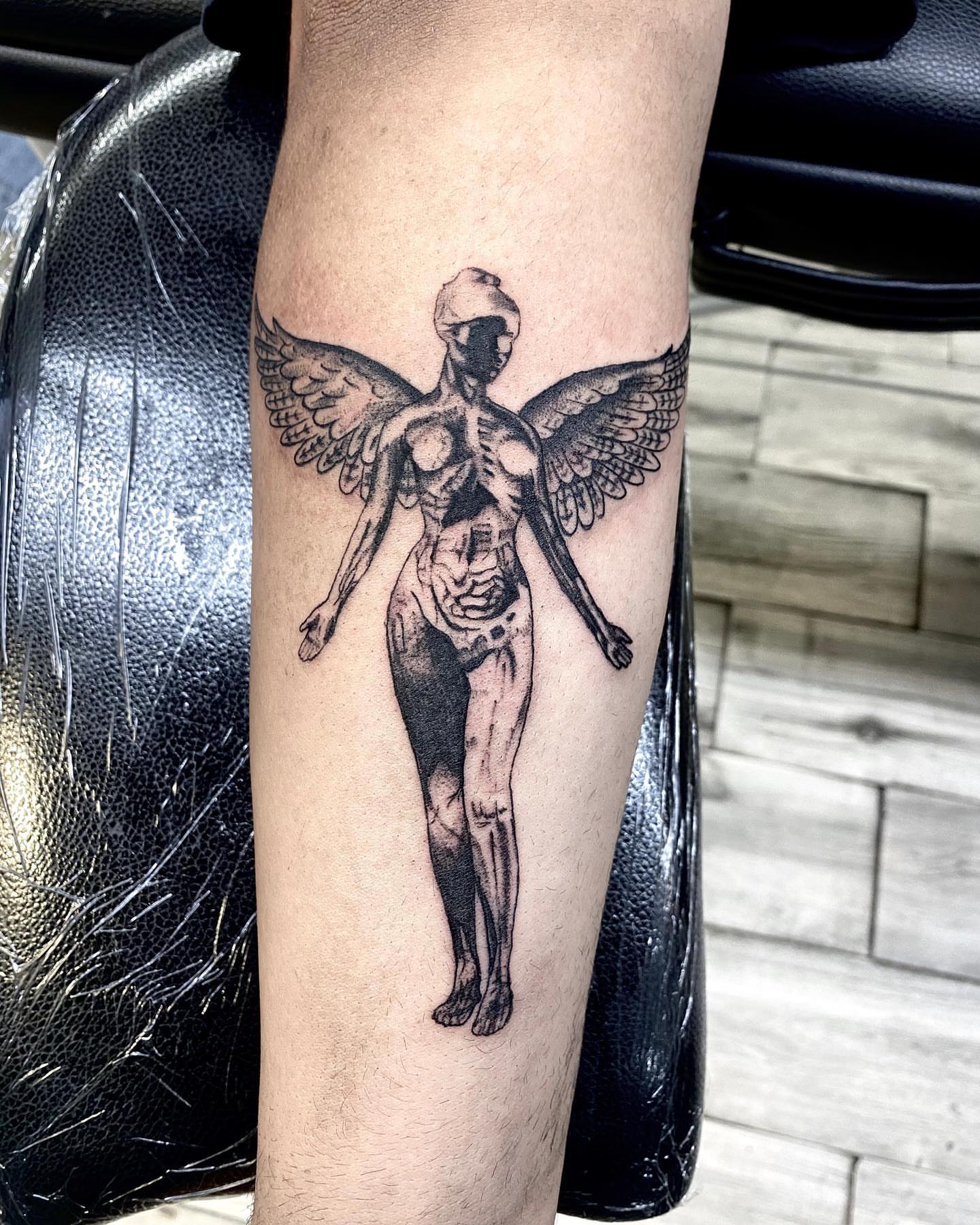 Winged skeleton black and grey tattoo on the forearm by Monique Ortiz, Mesa, Arizona