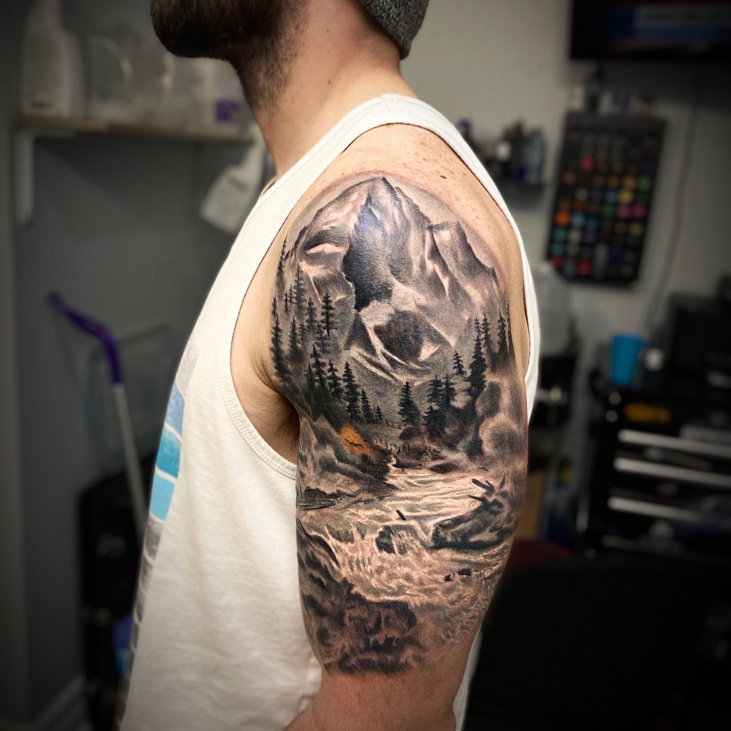 Mountain landscape realism tattoo on the upper arm by Levi Tattoo Artist, Utah