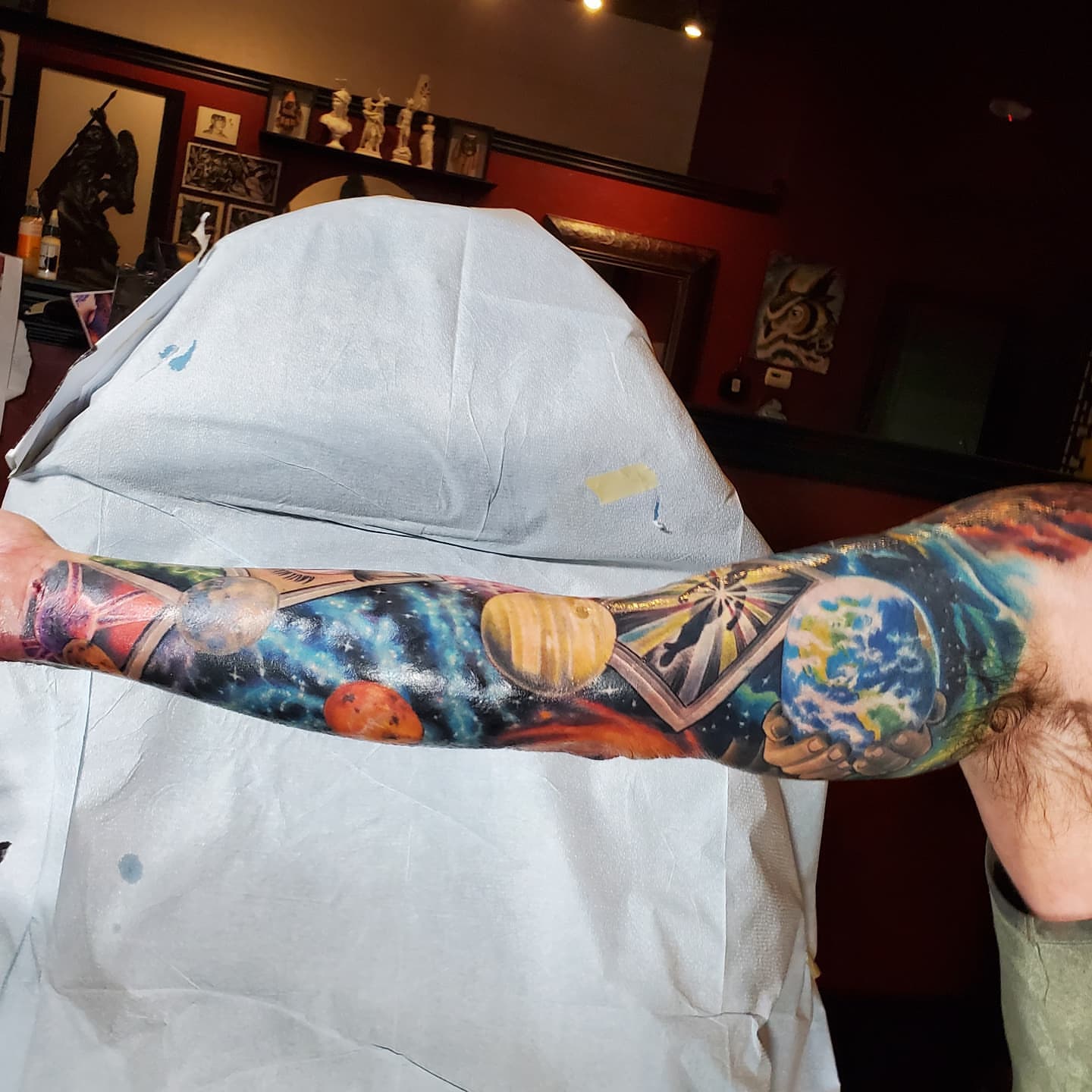 Space-themed celestial bodies realism tattoo on the upper arm by Jake Goss, Salt Lake City, Utah