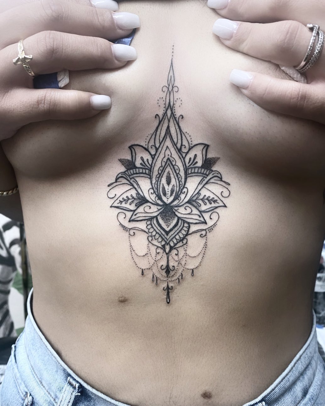 Lotus flower dotwork tattoo on the ribs by Dayana✨