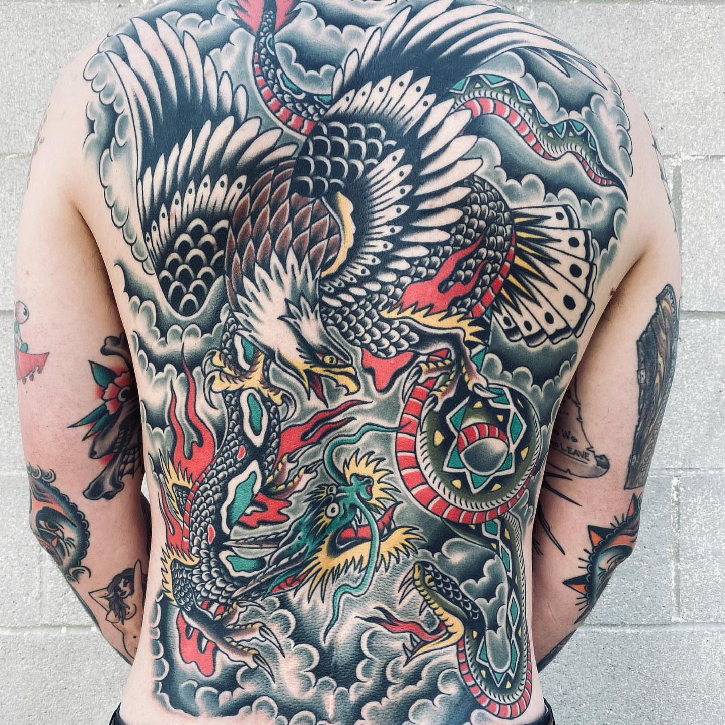 Dragon and snake American traditional tattoo on the back by Dave G