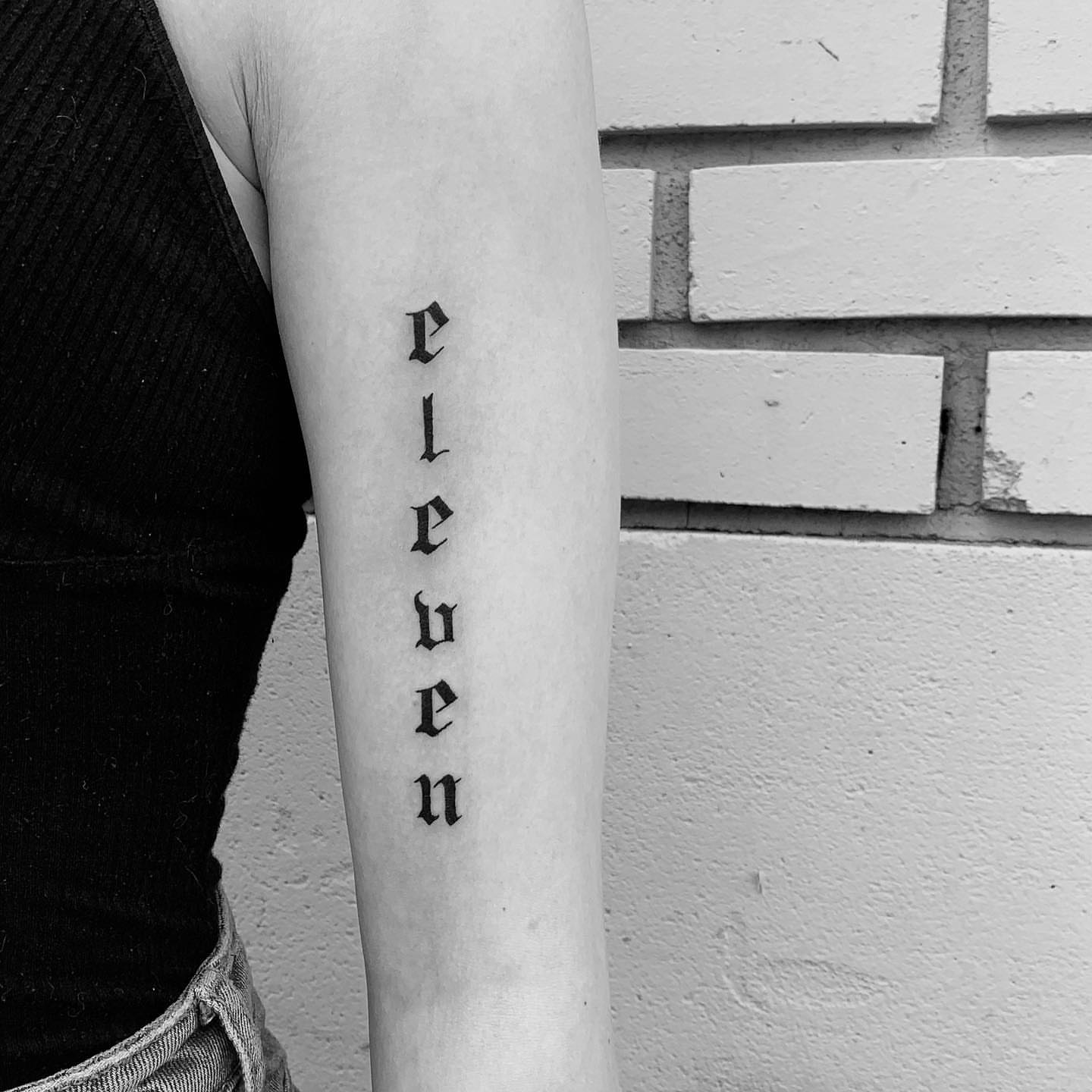 Eleven lettering script tattoo on the forearm by s͓̽a͓̽w͓̽n͓̽j͓̽a͓̽
