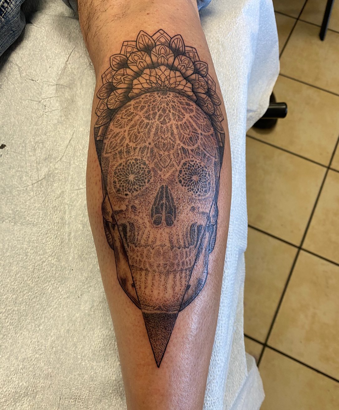 Skull dotwork tattoo on the forearm by Nicholas Jones