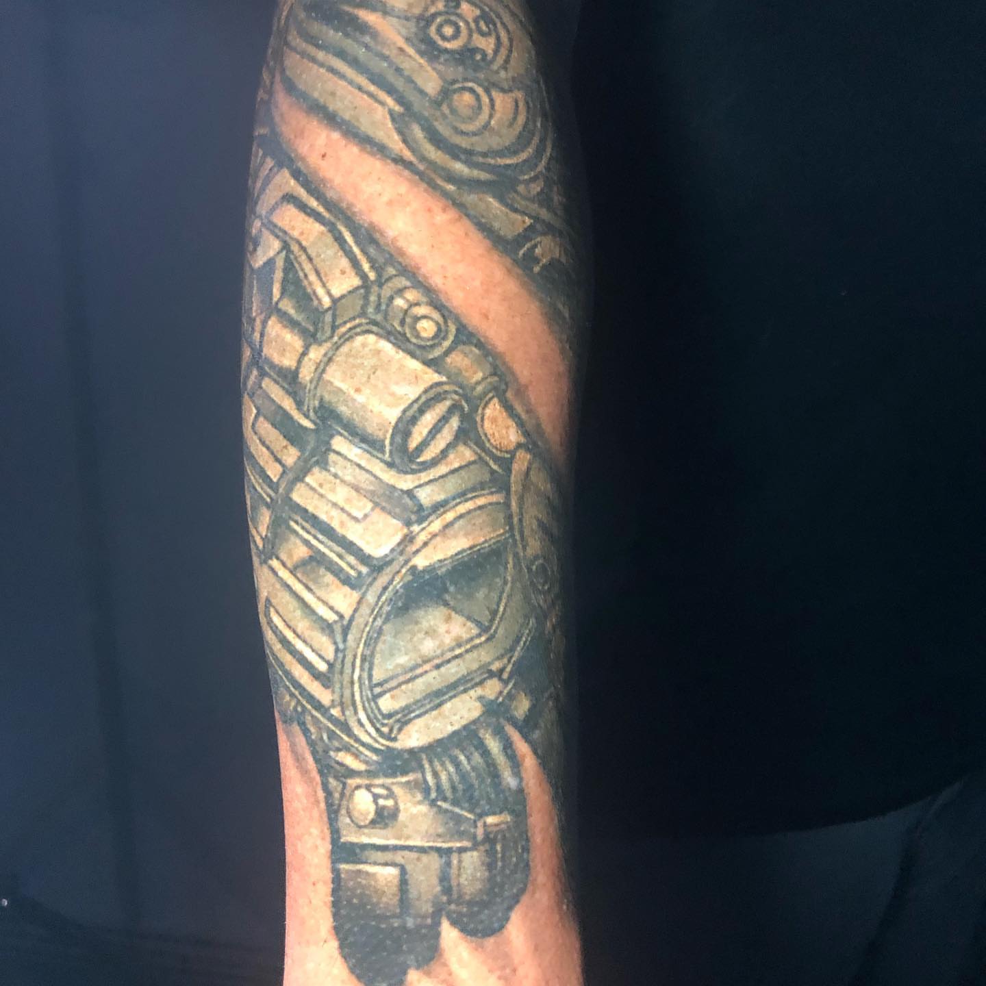 Mechanical gear black and grey tattoo on the forearm by Kayden DiGiovanni, Addison, Texas
