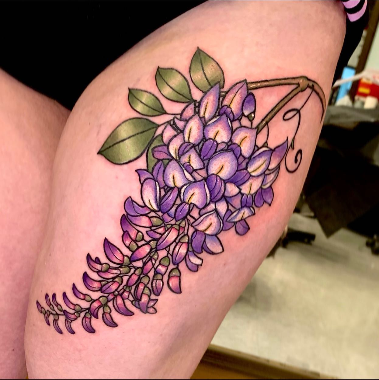 Wisteria realism tattoo on the thigh by Cortney Norton