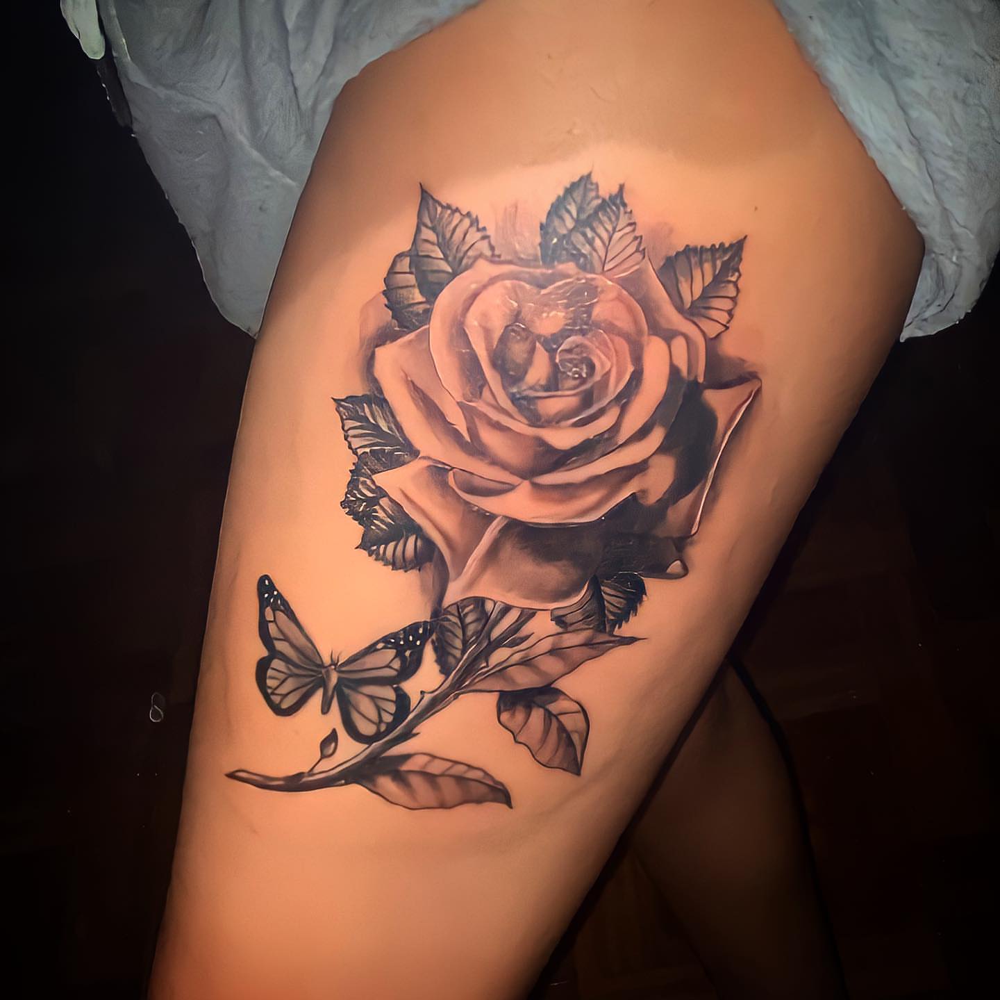 Rose and butterfly realism tattoo on the thigh by Immortal BAYAREA TATTOO ARTIST