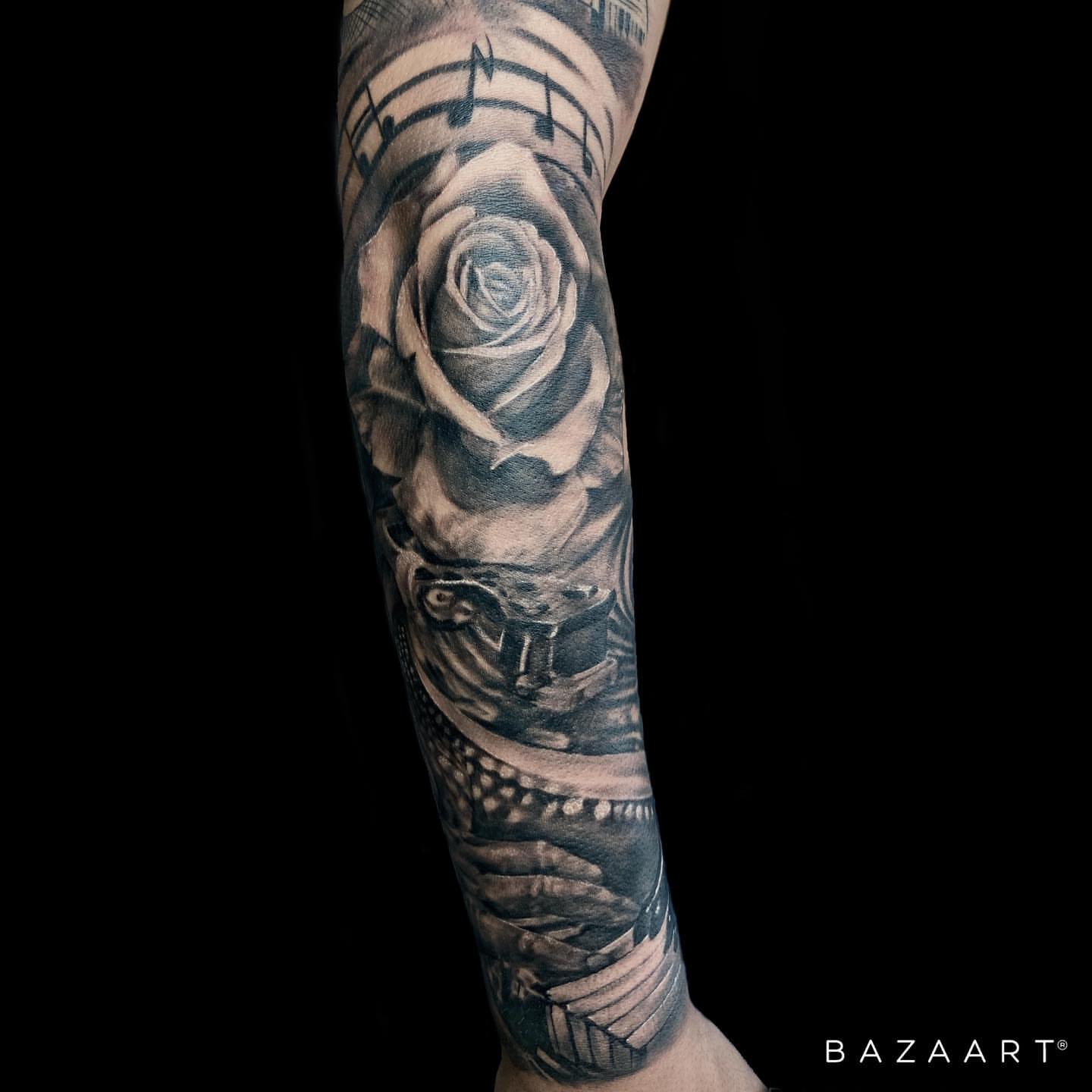 Rose and snake realism tattoo on the forearm by Adrian Gonzalez