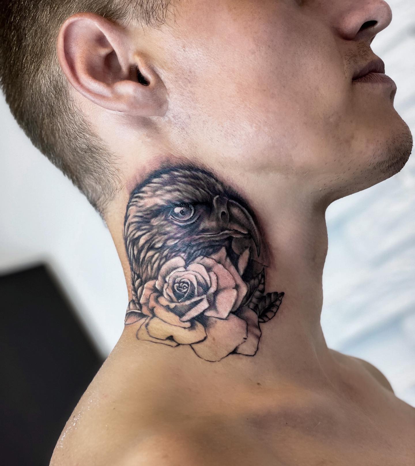 Eagle and rose realism tattoo on the neck by Annie Overchuk