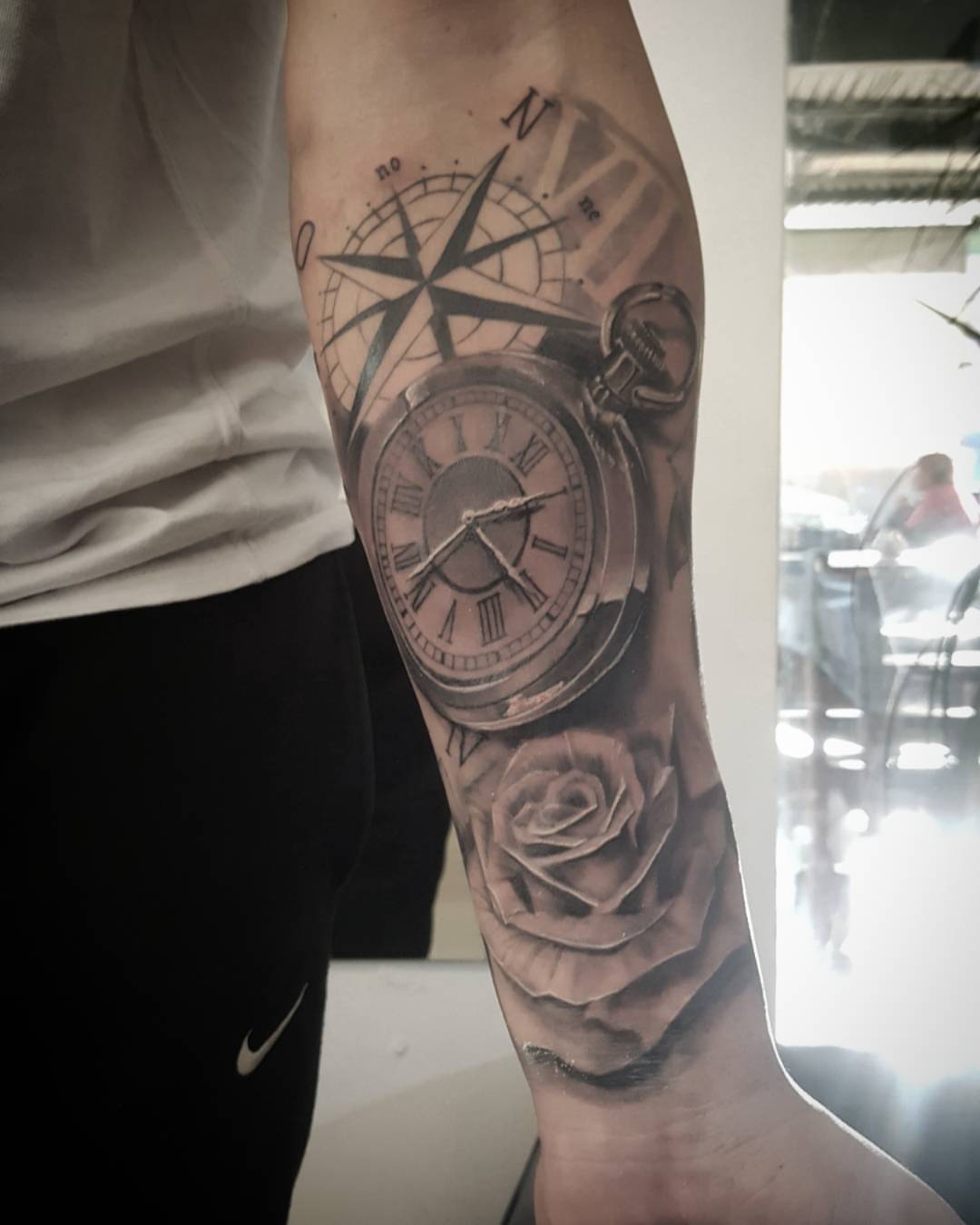 Compass, pocket watch, rose realism tattoo on the forearm by Pod Viñes