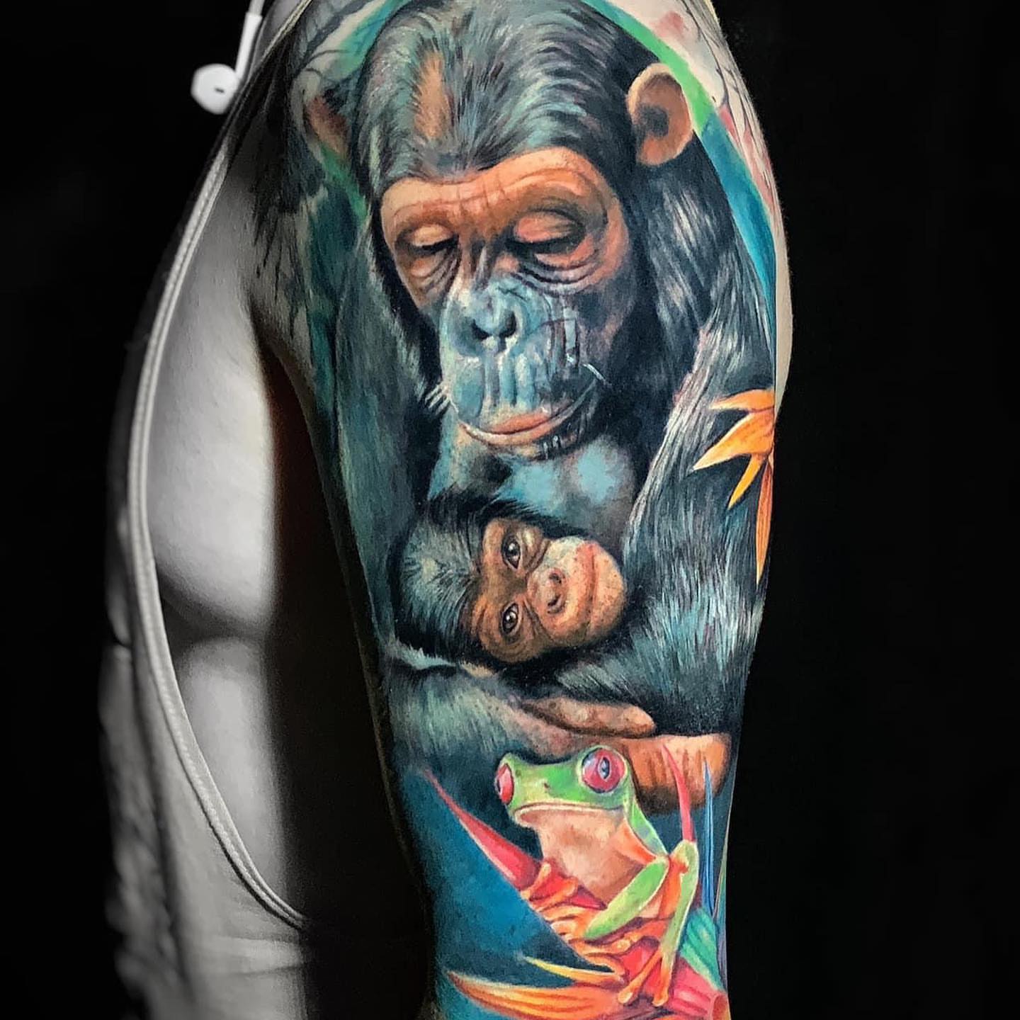 Chimpanzees and frog realism tattoo on the forearm by Daniela Duque Tattoo
