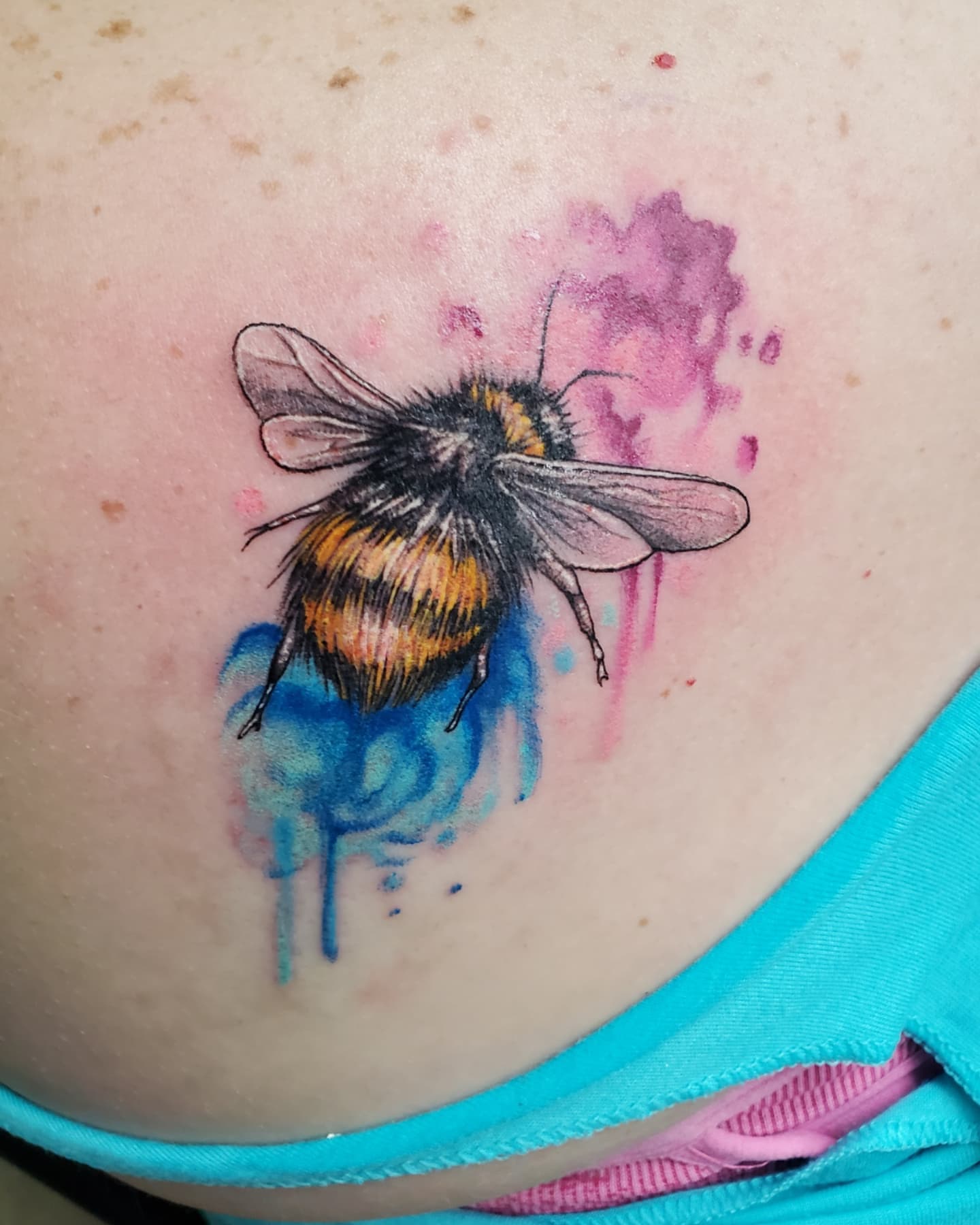 Bumblebee watercolor tattoo on the shoulder by Emily Jestine Francis