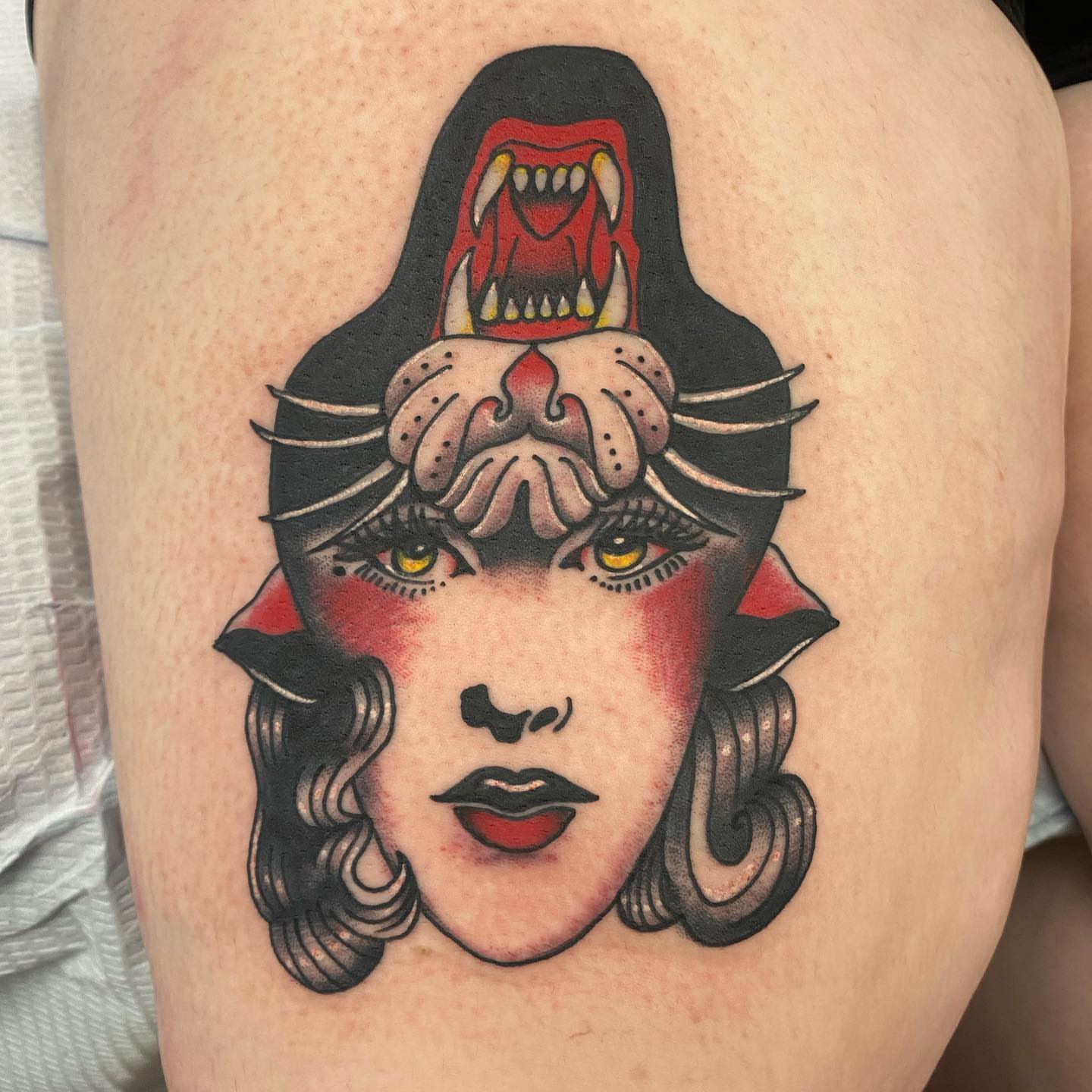 Woman with animal head American traditional tattoo on the thigh by Payton Prentice