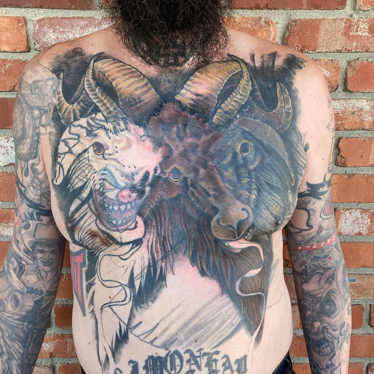 Ram heads realism tattoo on the back by Chuck House
