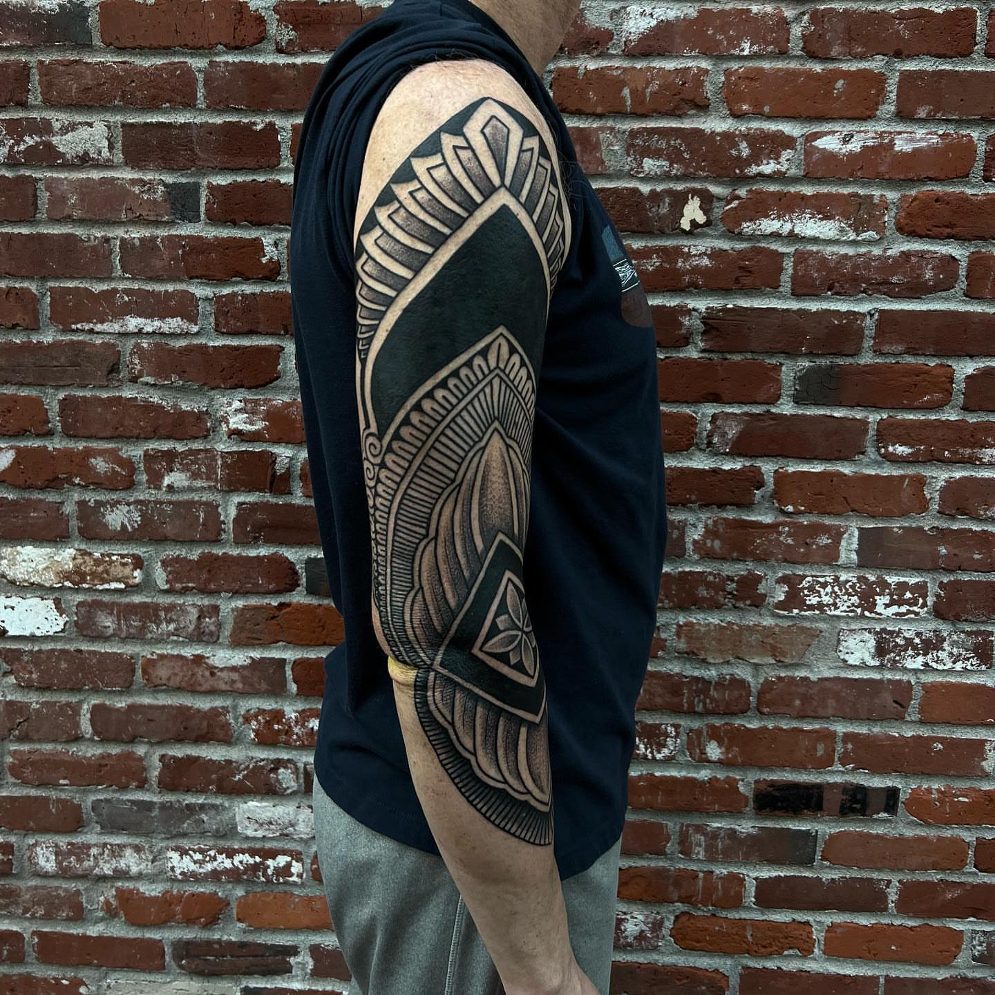 Geometric pattern geometric tattoo on the upper arm by Ałex, Portland, Oregon