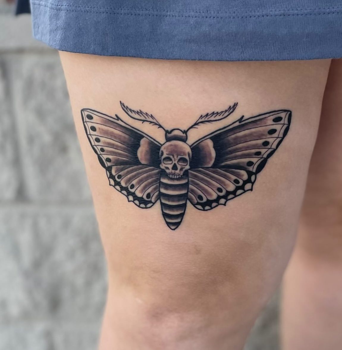 Moth with skull head black and grey tattoo on the thigh by Jacob Deirfield, Circleville, Ohio