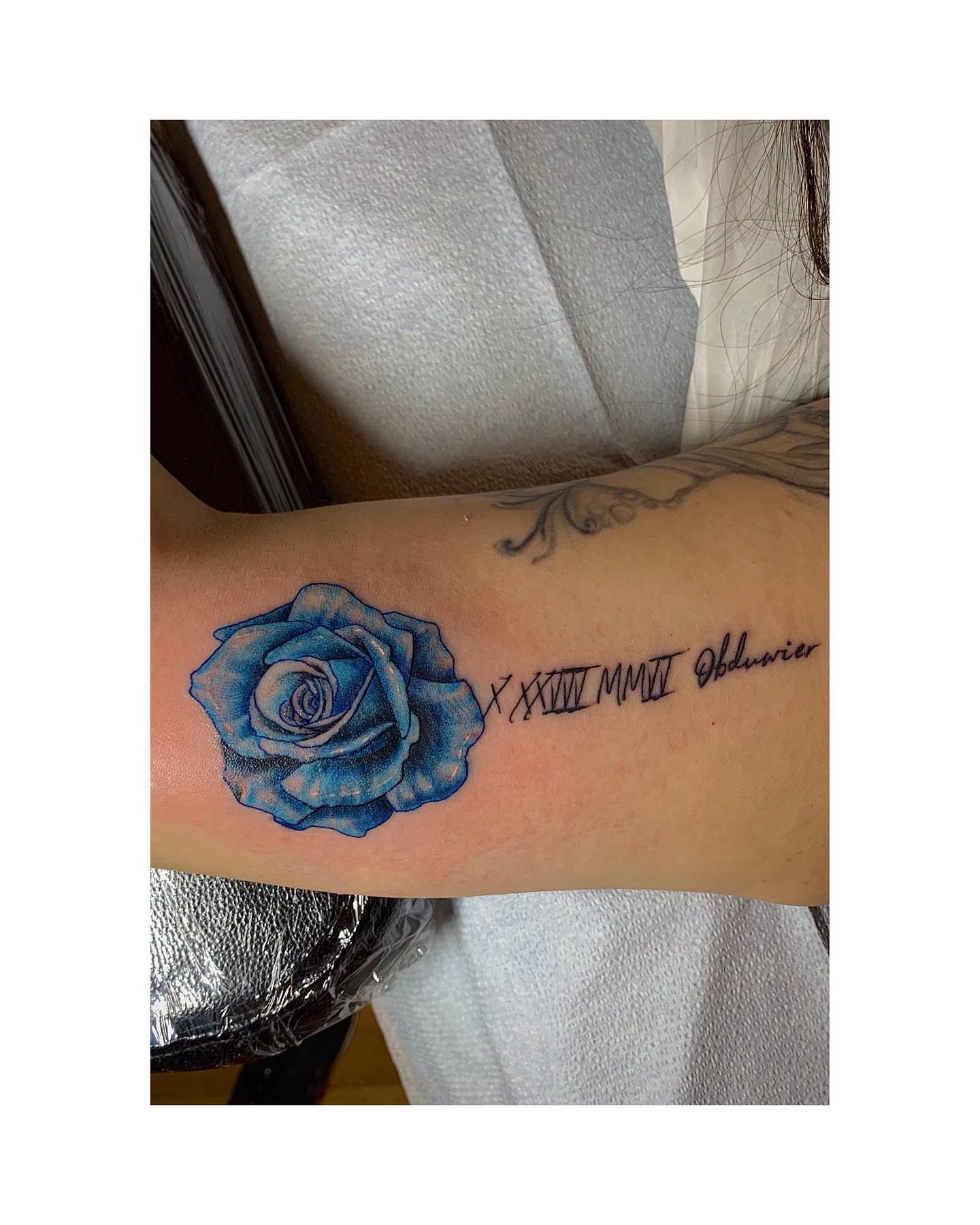 Blue rose realism tattoo on the forearm by Shamanic Ink