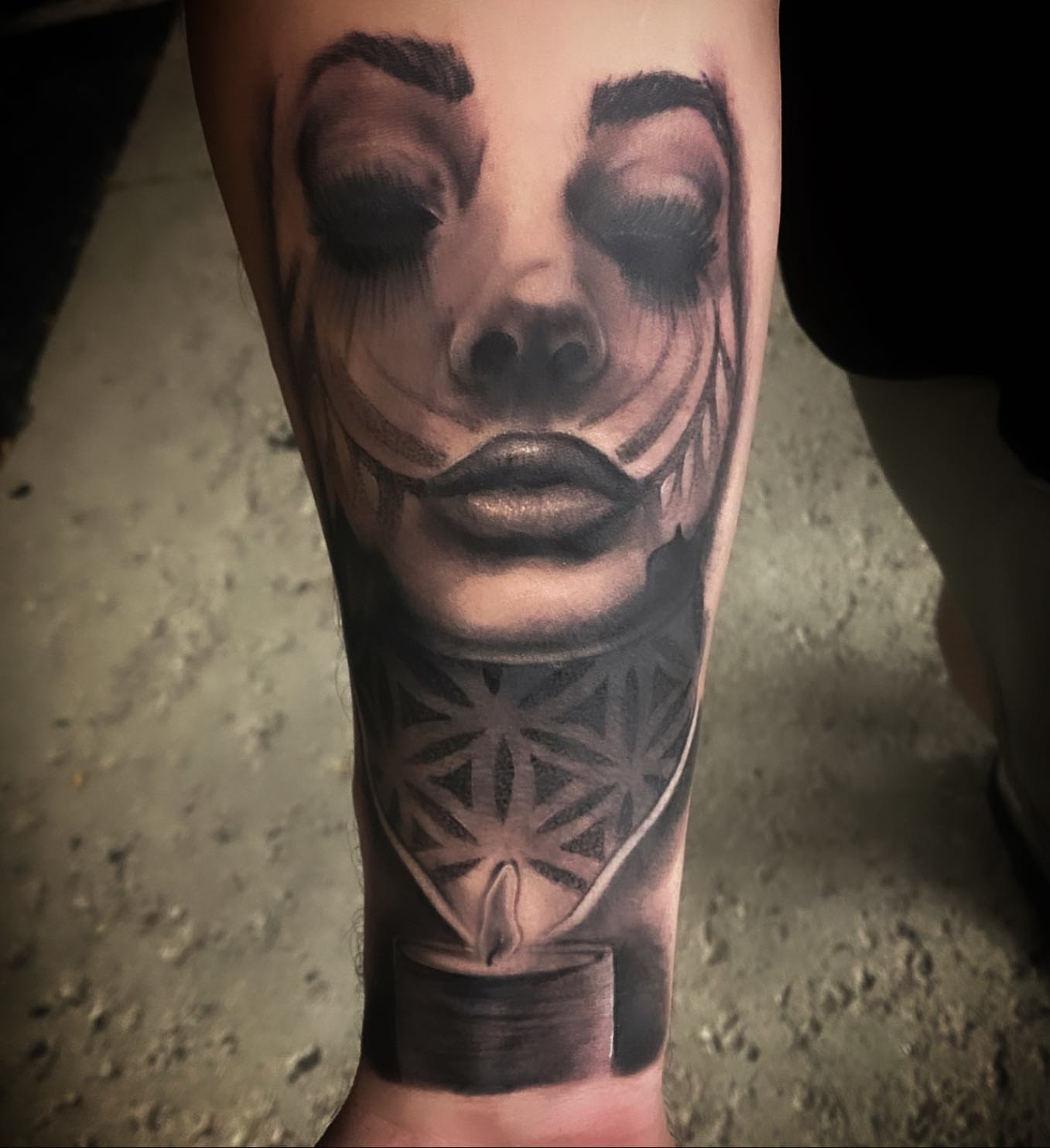 Abstract face dark realism tattoo on the forearm by Lauren Schwier