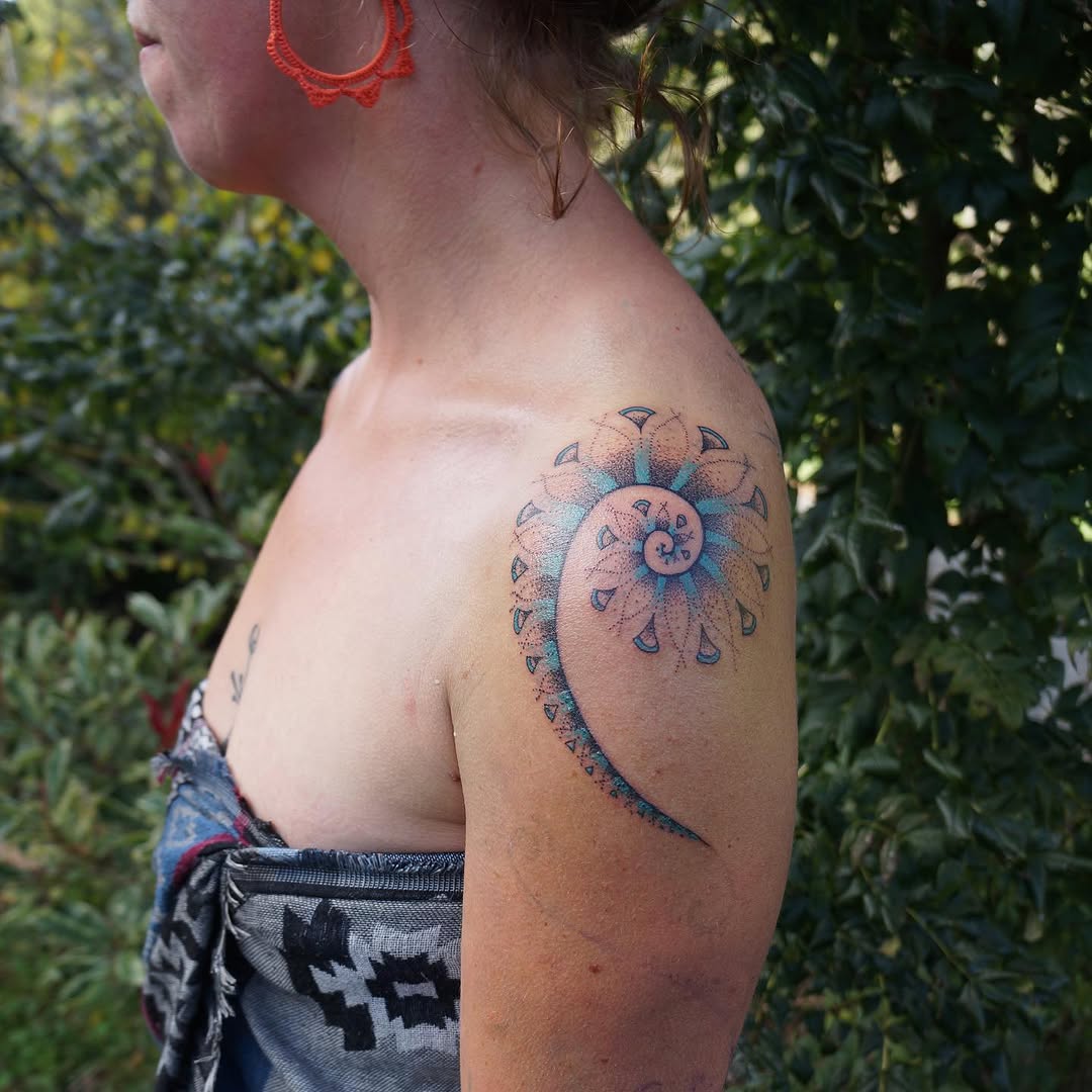 Geometric spiral dotwork tattoo on the shoulder by La Main Bleue