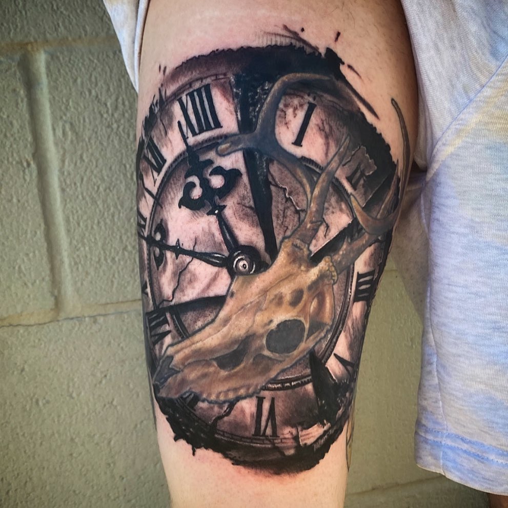 Clock and deer skull dark realism tattoo on the forearm by Lauren Schwier