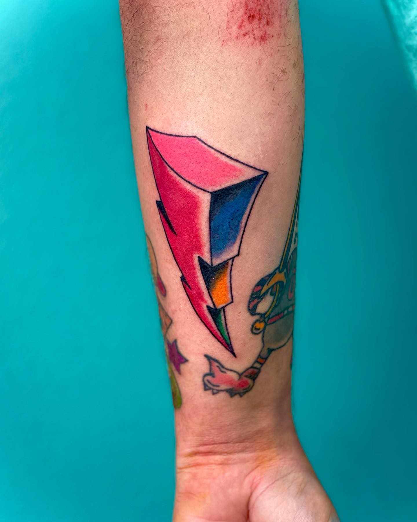 Geometric lightning bolt geometric tattoo on the forearm by Erin Stephens