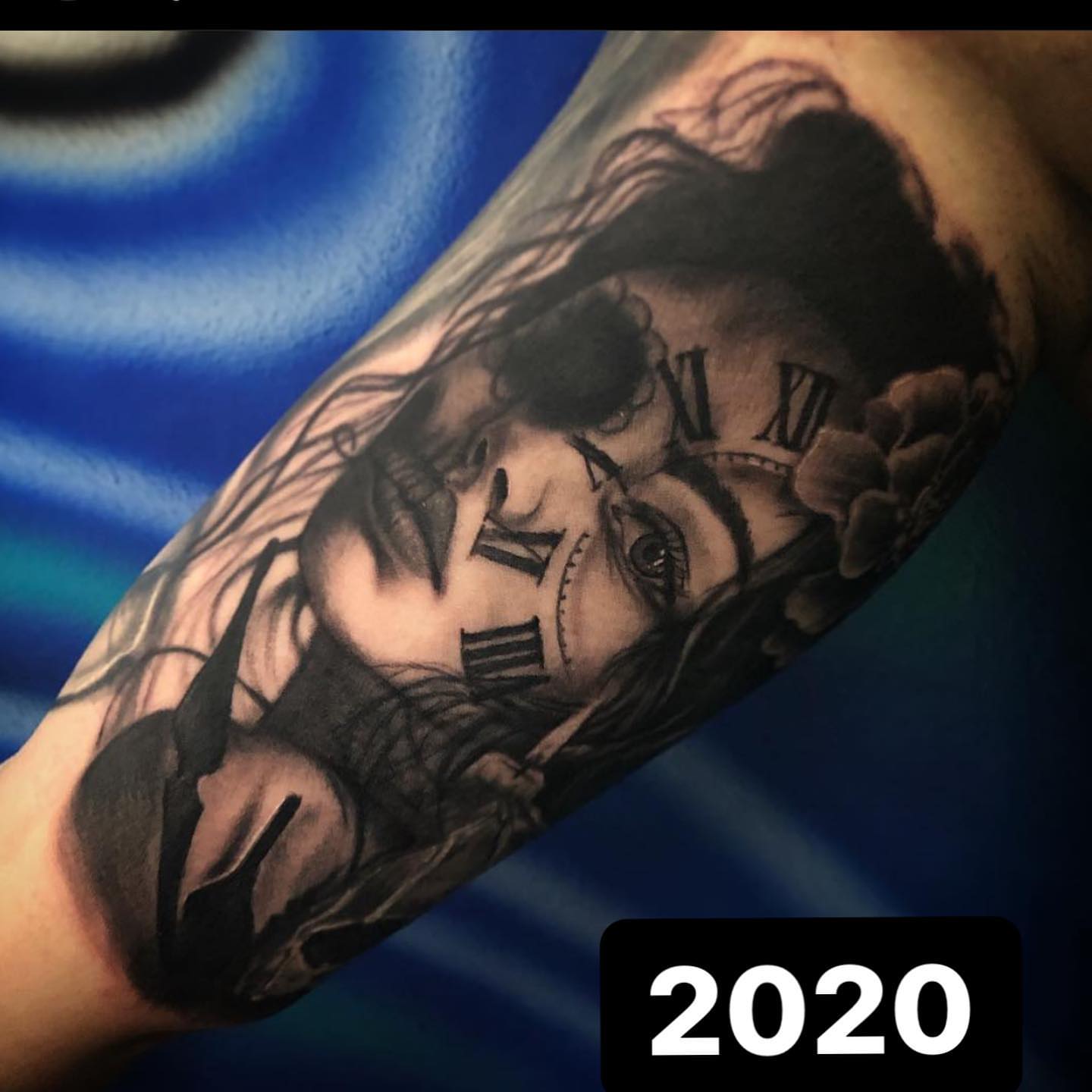 Woman's face with clock realism tattoo on the forearm by Lauren Schwier