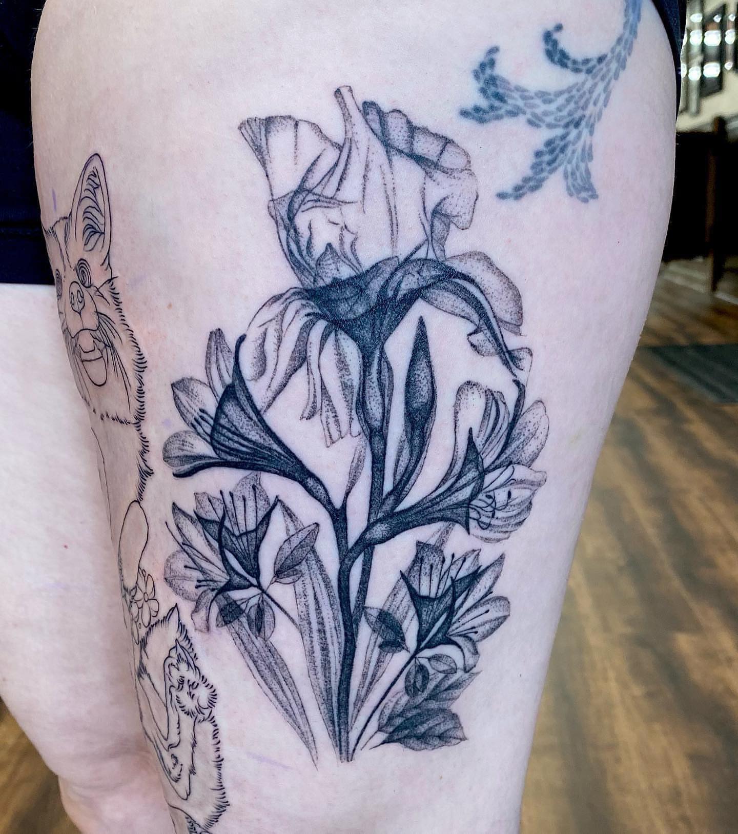 Iris flowers black and grey tattoo on the thigh by Ruby Gore, Portland, Oregon