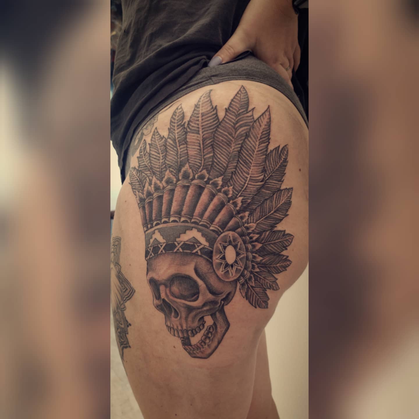 Skull with headdress realism tattoo on the thigh by Tyler Cromwell