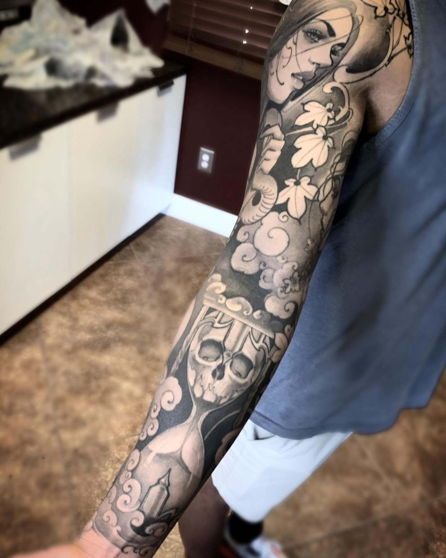 Skull and woman American traditional tattoo on the upper arm by Jeff Norton, Atascadero, California