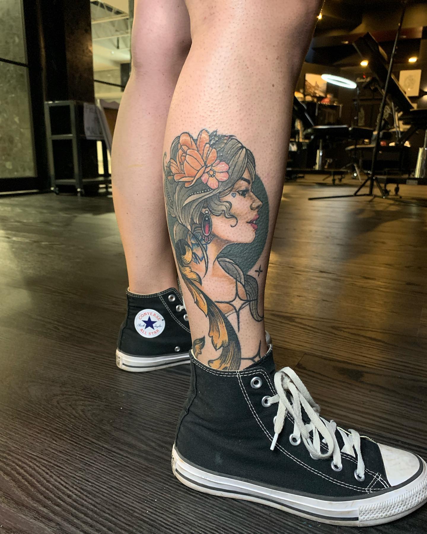 Woman with flowers American traditional tattoo on the calf by Seth Scott