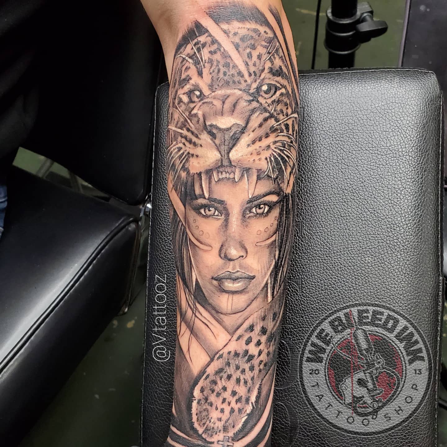Woman with leopard realism tattoo on the forearm by call (504)441-9275 for info