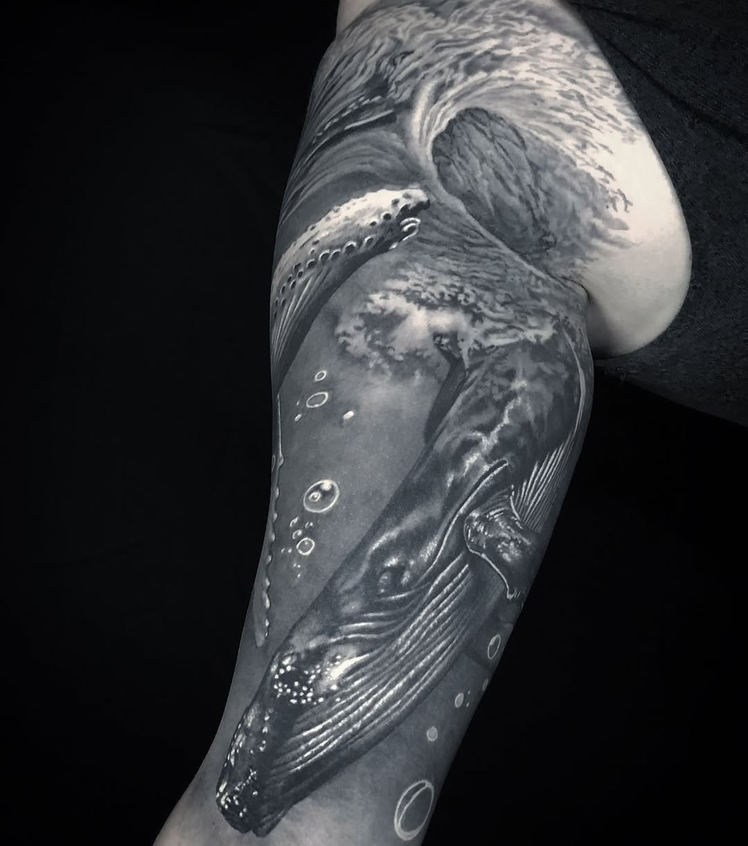 Whale and wave fine line tattoo on the forearm by Gabriel Londis