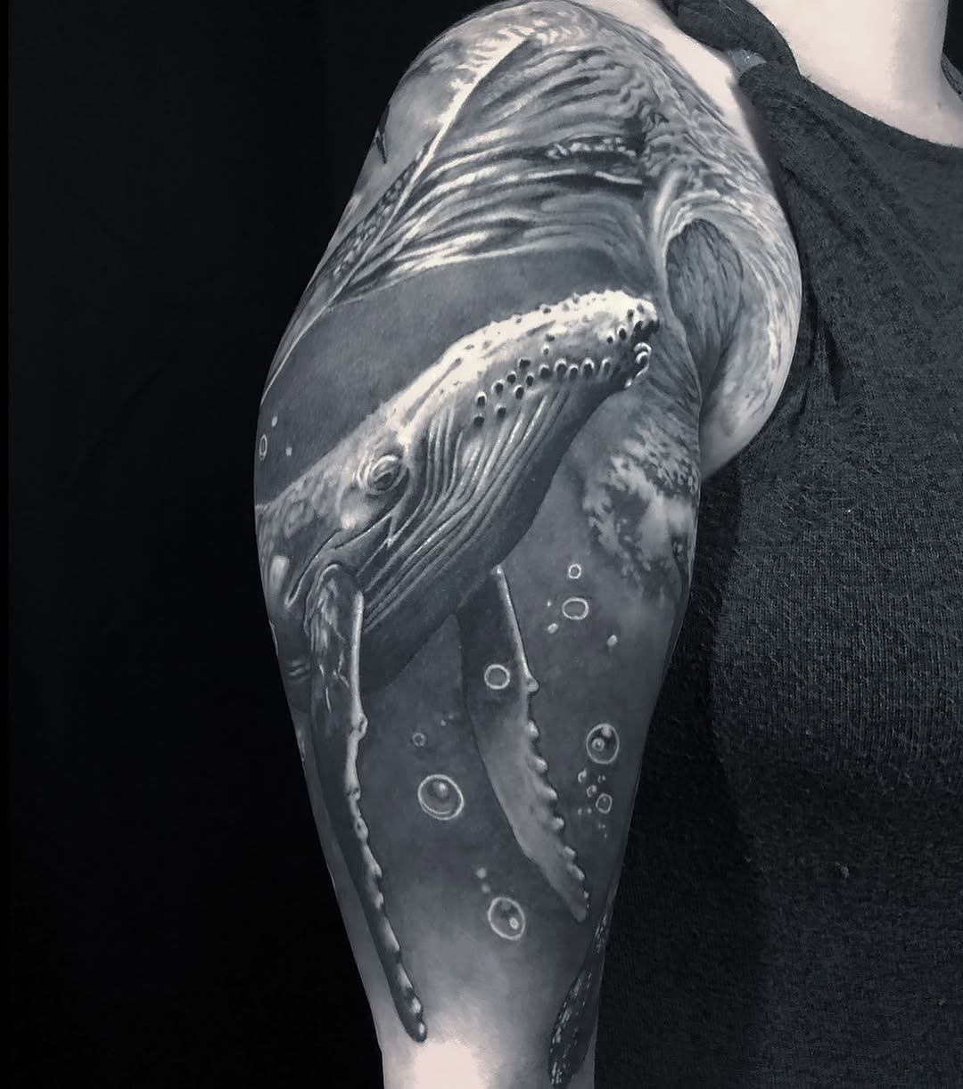 Humpback whale underwater fine line tattoo on the upper arm by Gabriel Londis