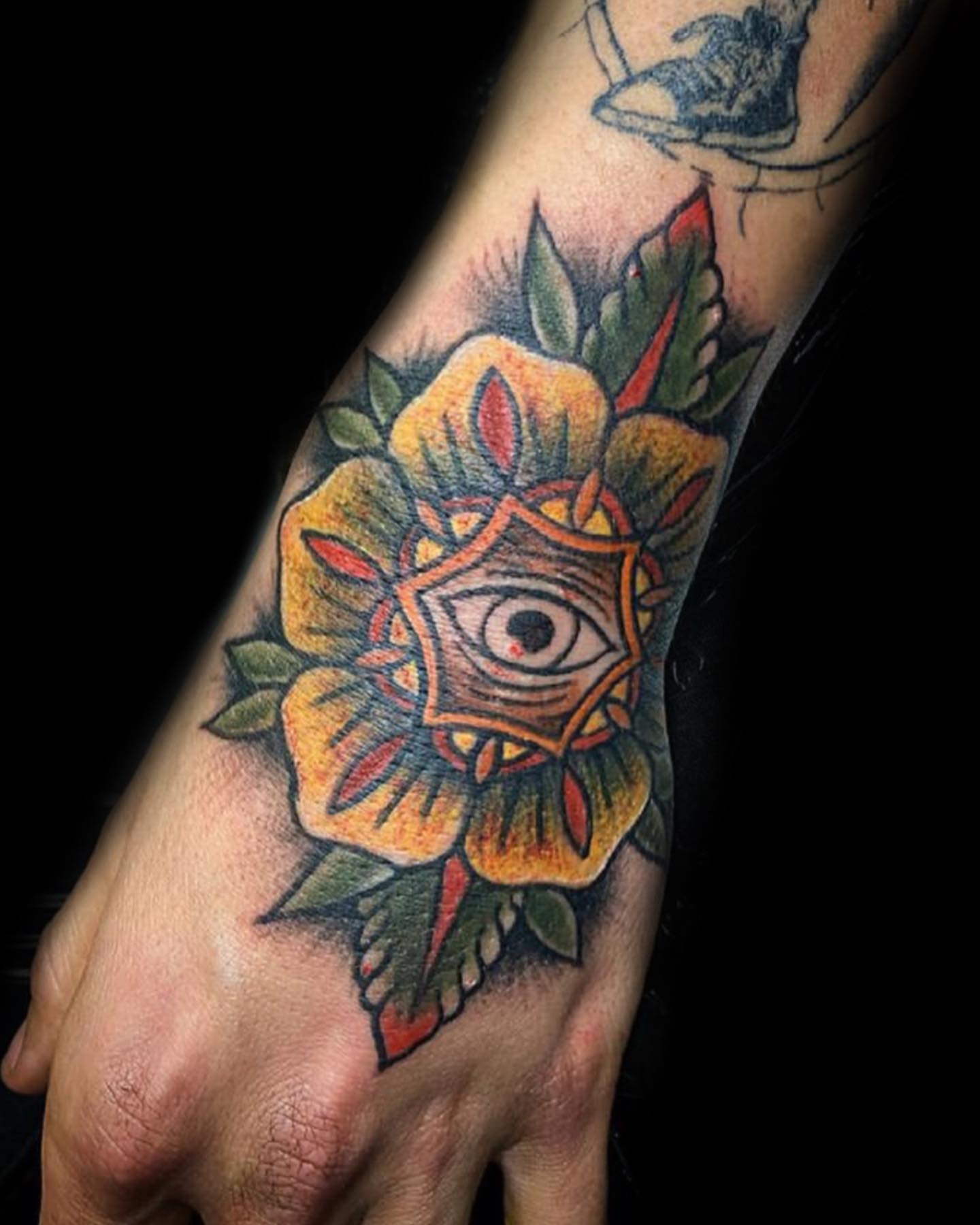 Eye within flower American traditional tattoo on the forearm by Visionary Tattoos