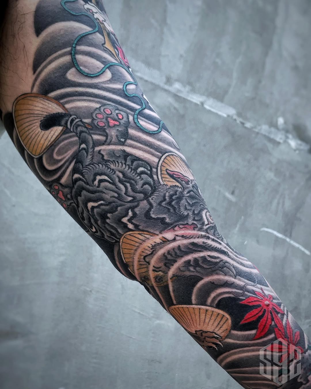 Cat and waves Japanese tattoo on the forearm by Scienz 九卦刺青