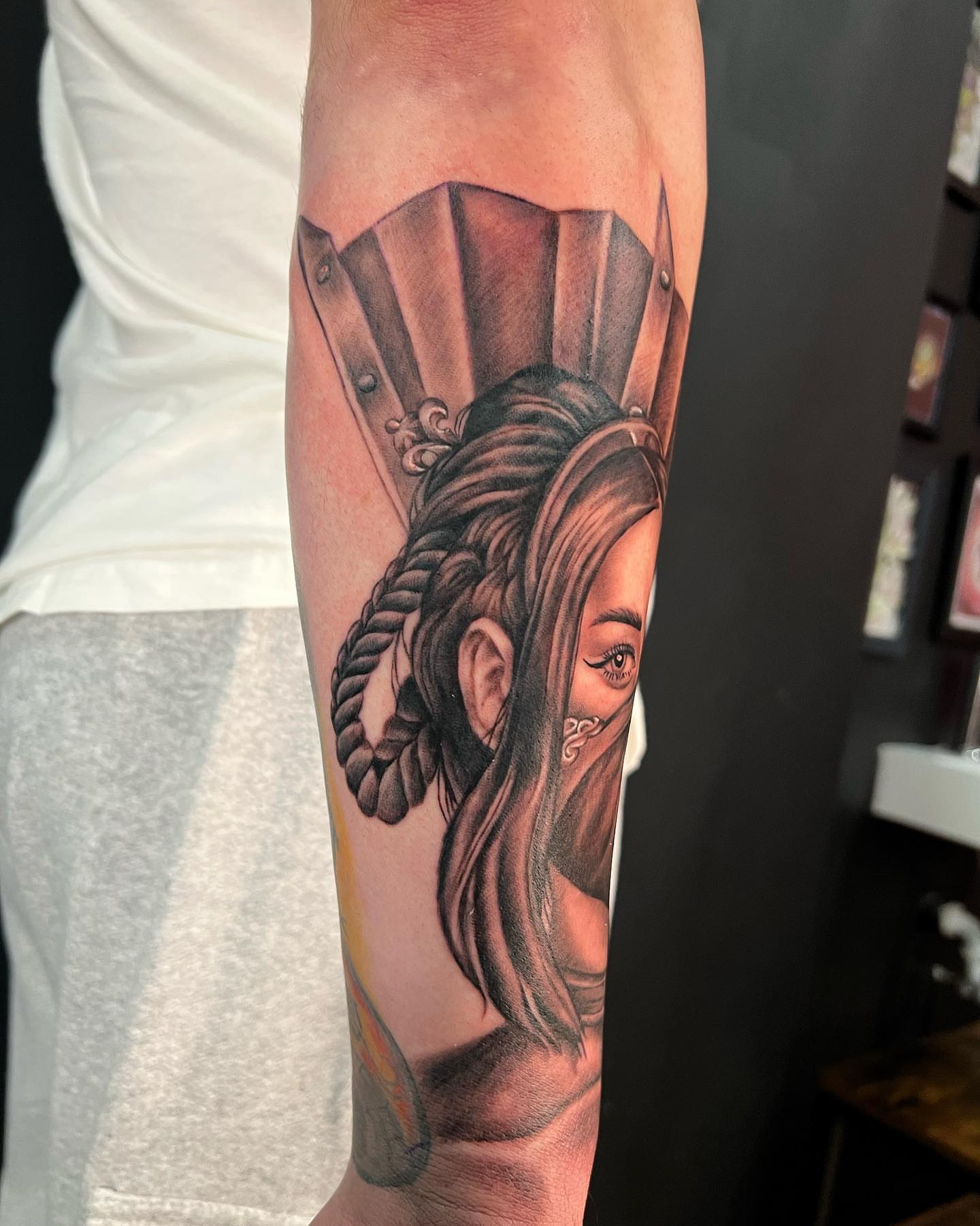 Woman with helmet realism tattoo on the forearm by CHiNO iNKs