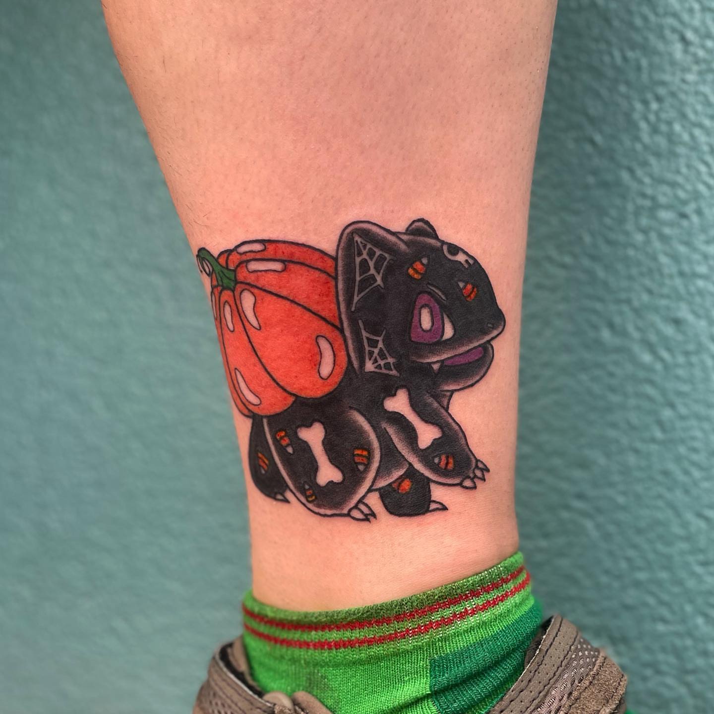 Pumpkin and ghost American traditional tattoo on the forearm by Erin Stephens