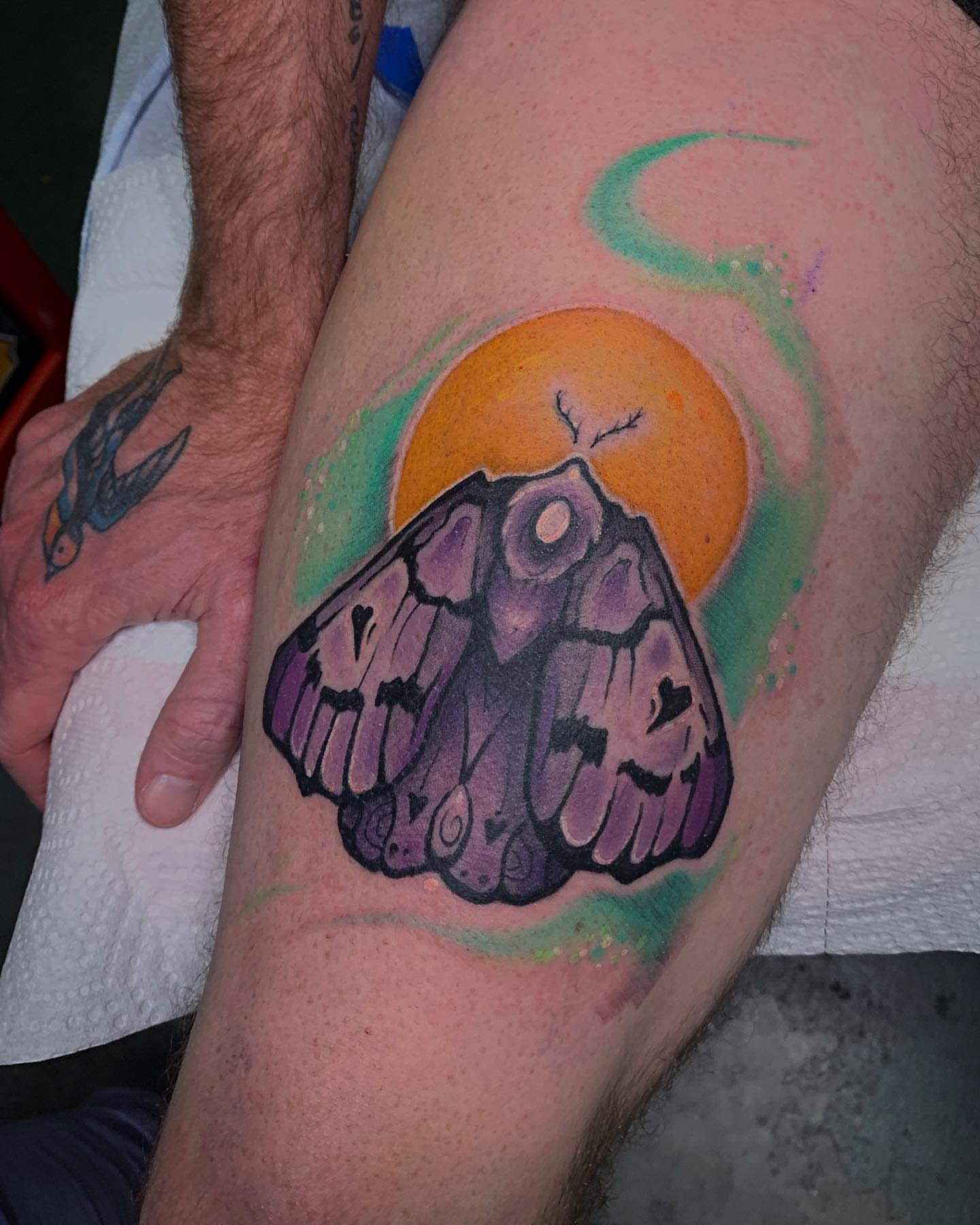 Moth watercolor tattoo on the thigh by Riley Oats