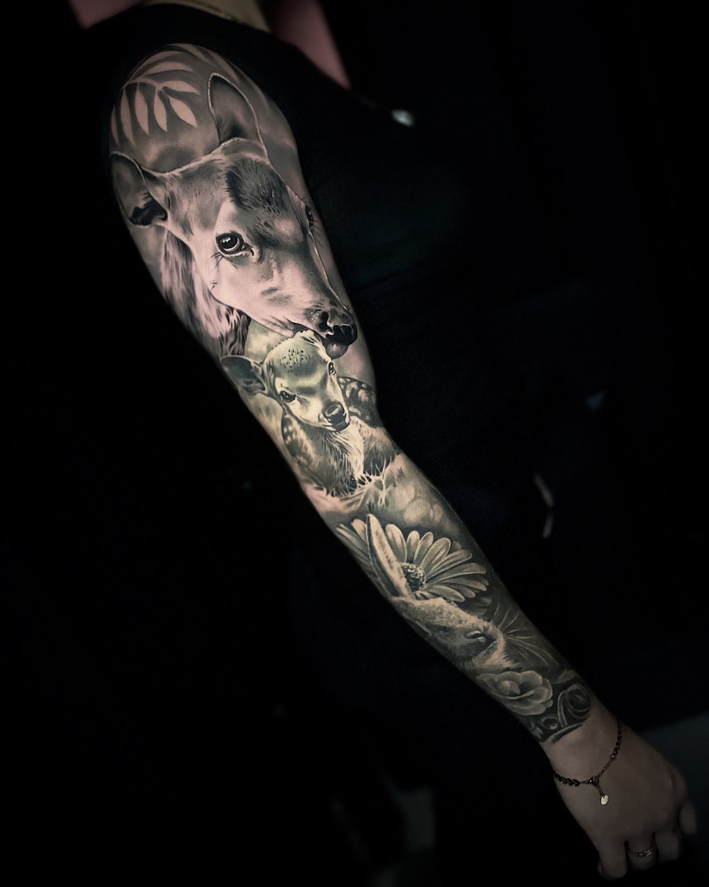 Deer and flowers realism tattoo on the forearm by Dayron Gonzalez